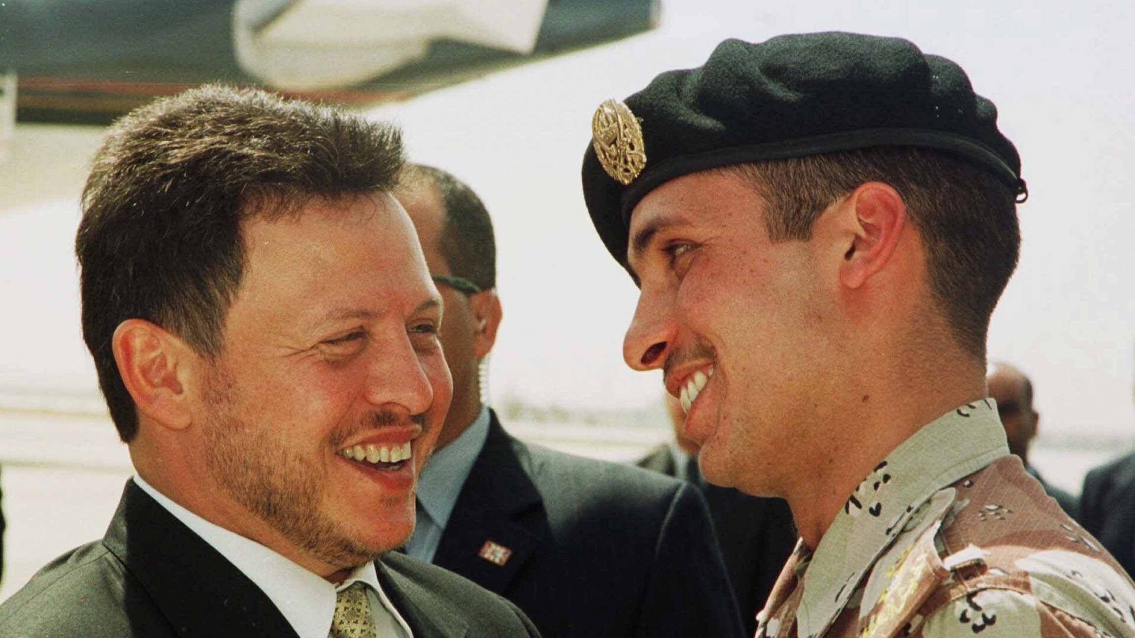 In this April 2, 2001, file photo, Jordan’s King Abdullah II laughs with his half-brother Prince Hamzah (right) shortly before the monarch embarked on a tour of the United States. Prince Hamzah said in a recording released Monday, April 5, that he will de Two people lean in and laugh, talk with each other.