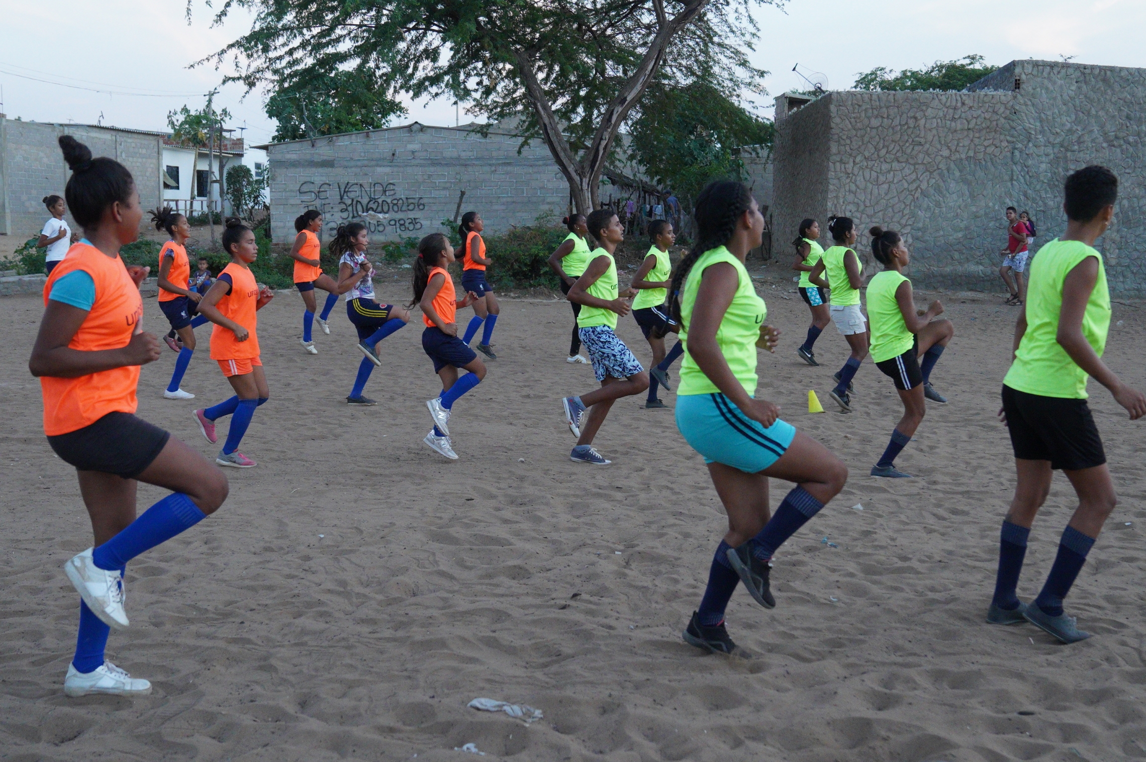Kickball players in the Brisas del Norte neighborhood do a warm up drill before a match. The league is open to children and adults. Kickball players in the Brisas del Norte neighborhood do a warm up drill before a match. The league is open to children and adults.