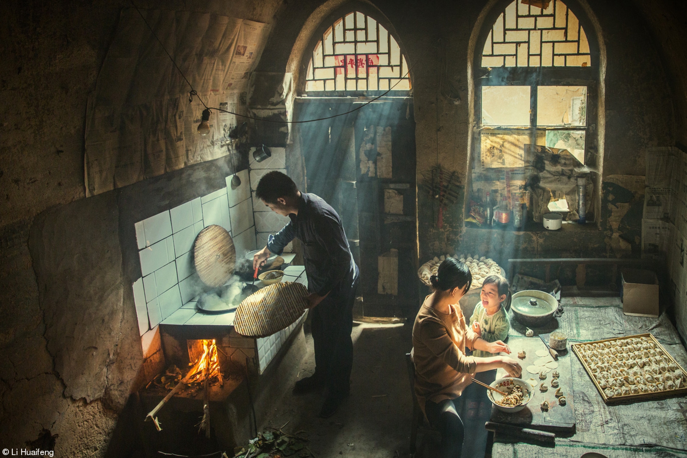 "Taste" was taken in Licheng, Shanxi, China on a warm and sunny day, and shows a young family sharing in the joy of preparing food. A man is shown tending to cooking with a woman behind him preparing good next to a young child.