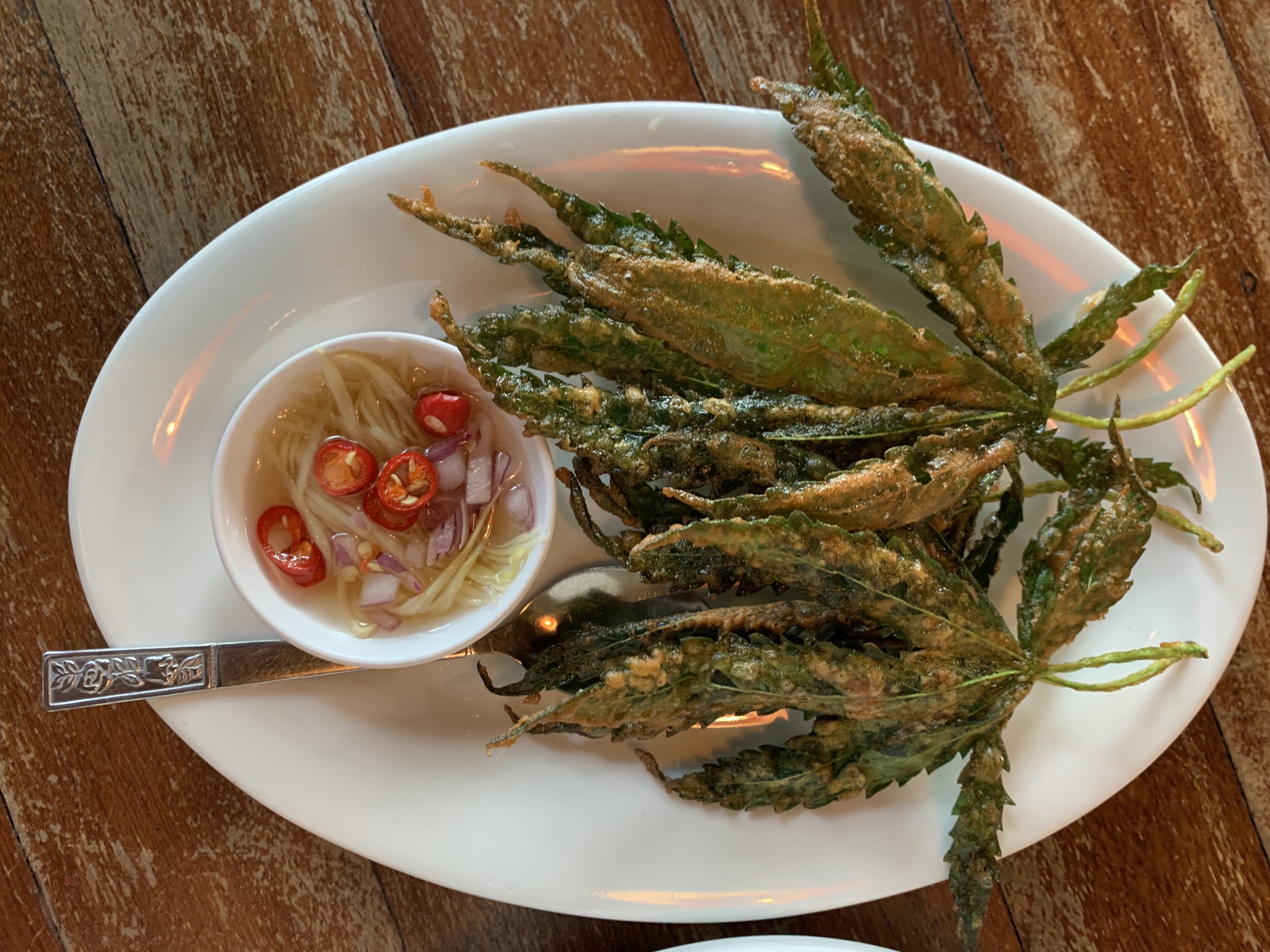 Cannabis leaves are incorporated into dishes at a restaurant called Baan Lao Ruang (The Storytelling House) in a rural area outside of Bangkok. Cannabis leaves are incorporated into dishes at a restaurant called Baan Lao Ruang (The Storytelling House) in a rural area outside of Bangkok.