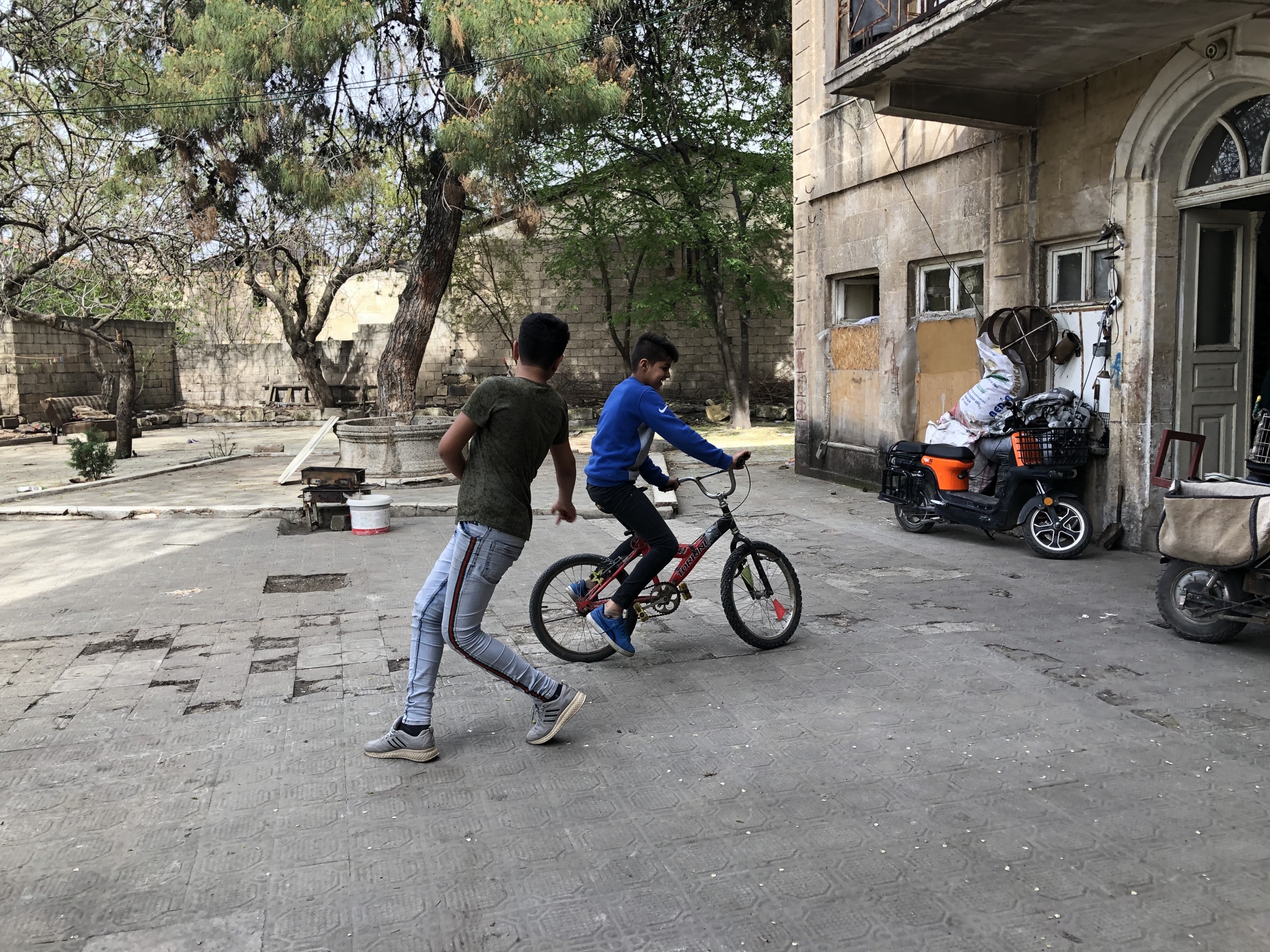 Salim Abdul Ghani has been checking in with Sharifa Riza and her four young sons since the start of the pandemic. They live in an abandoned house tucked away at the end of a narrow alleyway. Riza’s sons went to the Rainbow Center. Salim Abdul Ghani has been checking in with Sharifa Riza and her four young sons since the start of the pandemic. They live in an abandoned house tucked away at the end of a narrow alleyway. Riza’s sons went to the Rainbow Center.