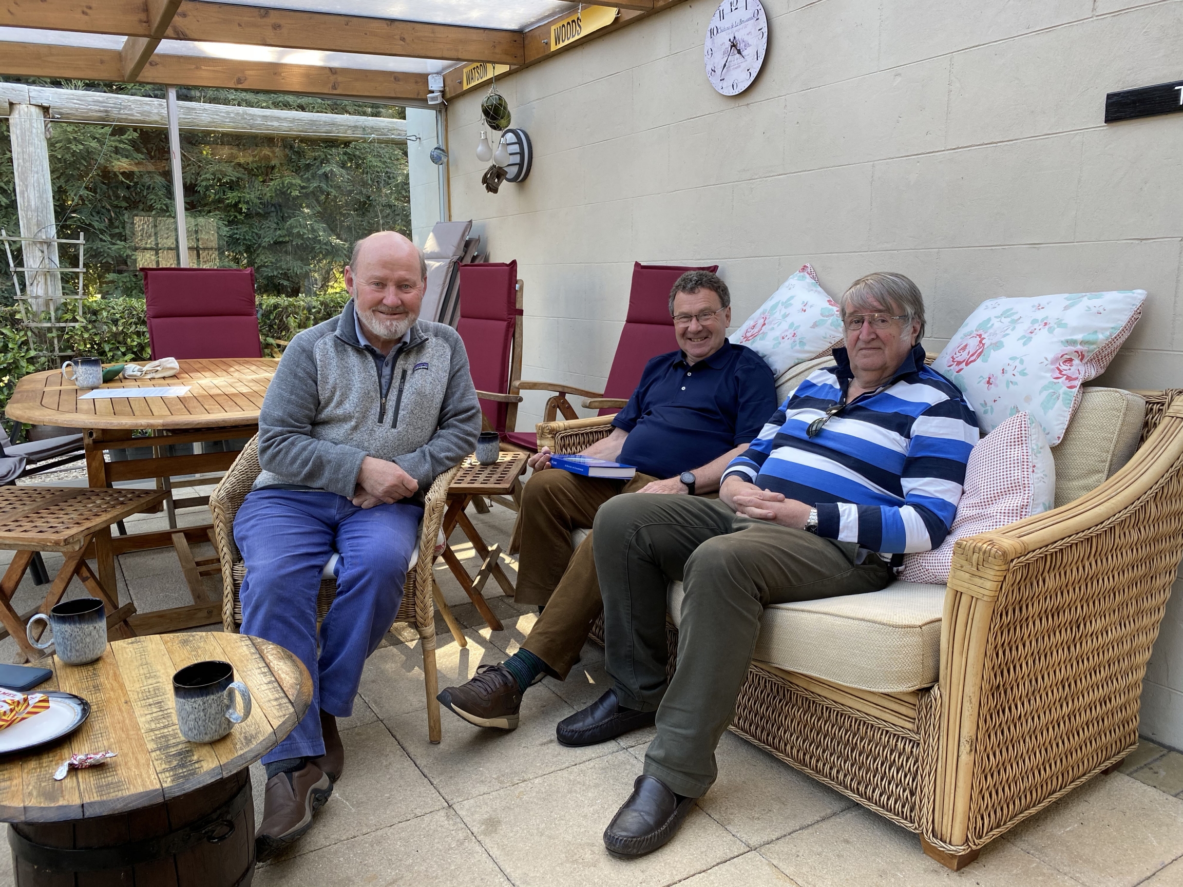Friends with polite disagreements over Scottish independence Three white men wearing casual clothes sit in a room together with a coffee table nearby.