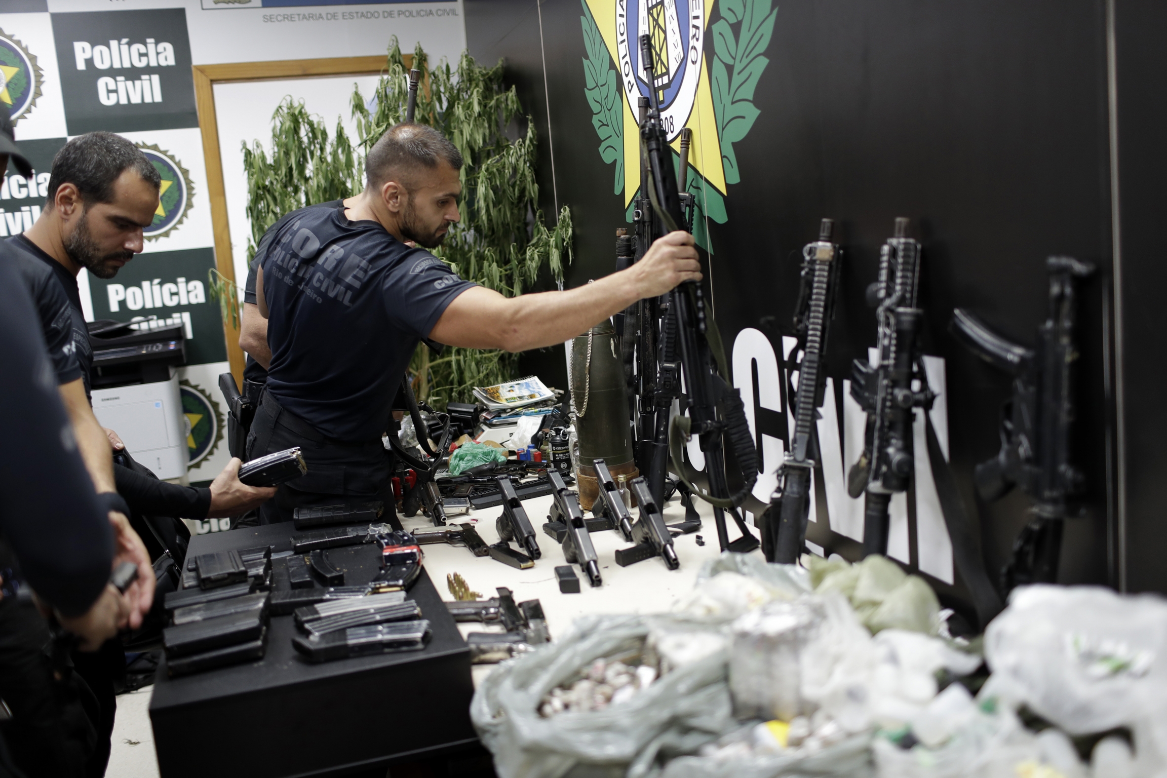 Weapons and drugs seized during a police raid are displayed for the press at city police headquarters in Rio de Janeiro, Brazil, May 6, 2021. Weapons and drugs seized during a police raid are displayed for the press at city police headquarters in Rio de Janeiro, Brazil, May 6, 2021.