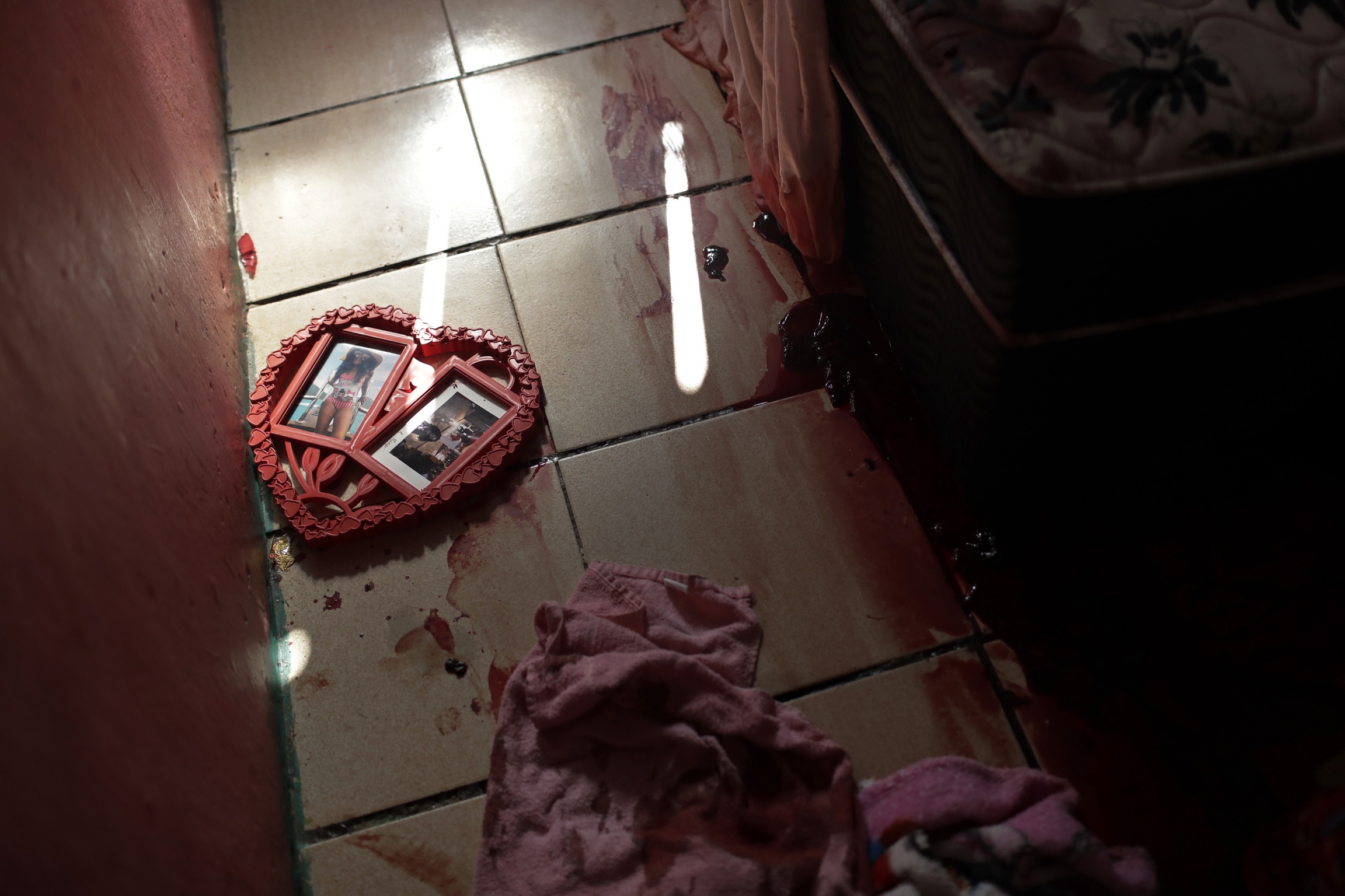 Blood covers the floor and a picture frame in a shape of a heart, inside a home during a police raid targeting drug traffickers in the Jacarezinho favela of Rio de Janeiro, Brazil, May 6, 2021. Blood covers the floor and a picture frame in a shape of a heart, inside a home during a police raid targeting drug traffickers in the Jacarezinho favela of Rio de Janeiro, Brazil, May 6, 2021.