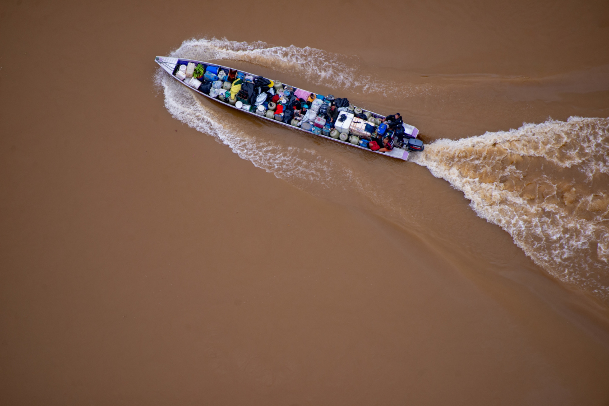 A boat transporting equipment for illegal mining operations in Yanomami Territory. A boat transporting equipment for illegal mining operations in Yanomami Territory.