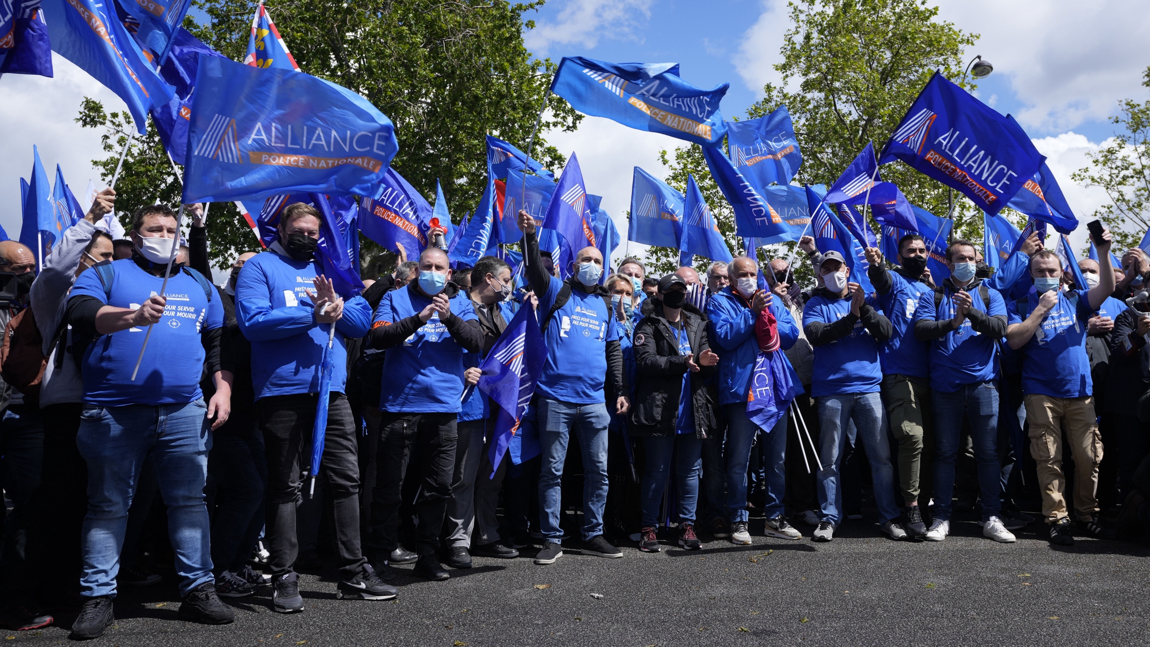 French police officers demonstrate Wednesday, May 19, 2021 in Paris. French police, feeling angry, vulnerable to attacks and useless, are holding an unusual demonstration Wednesday outside parliament to press for a law that protects the protectors. French police officers wearing blue shirts and waving blue flags demonstrate Wednesday, May 19, 2021 in Paris. French police, feeling angry, vulnerable to attacks and useless