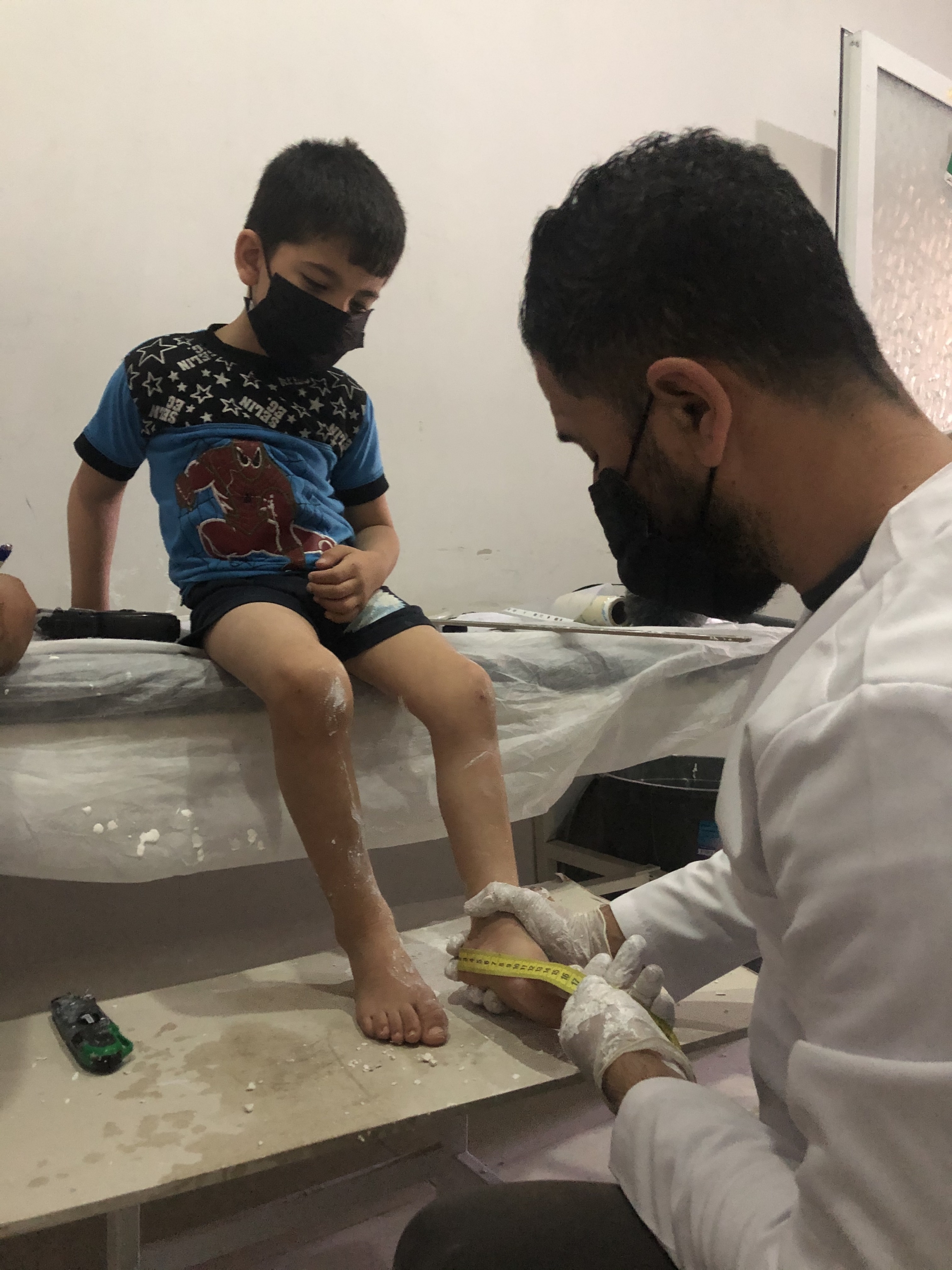 Five-year-old Jad al-Aweis suffers from cerebral palsy due to lack of oxygen at birth. Here, a specialist at a prosthetic limbs center in Turkey takes measurements of his legs so he can make braces that will help Jad walk. Five-year-old Jad al-Aweis suffers from cerebral palsy due to lack of oxygen at birth. Here, a specialist at a prosthetic limbs center in Turkey takes measurements of his legs so he can make braces that will help Jad walk.