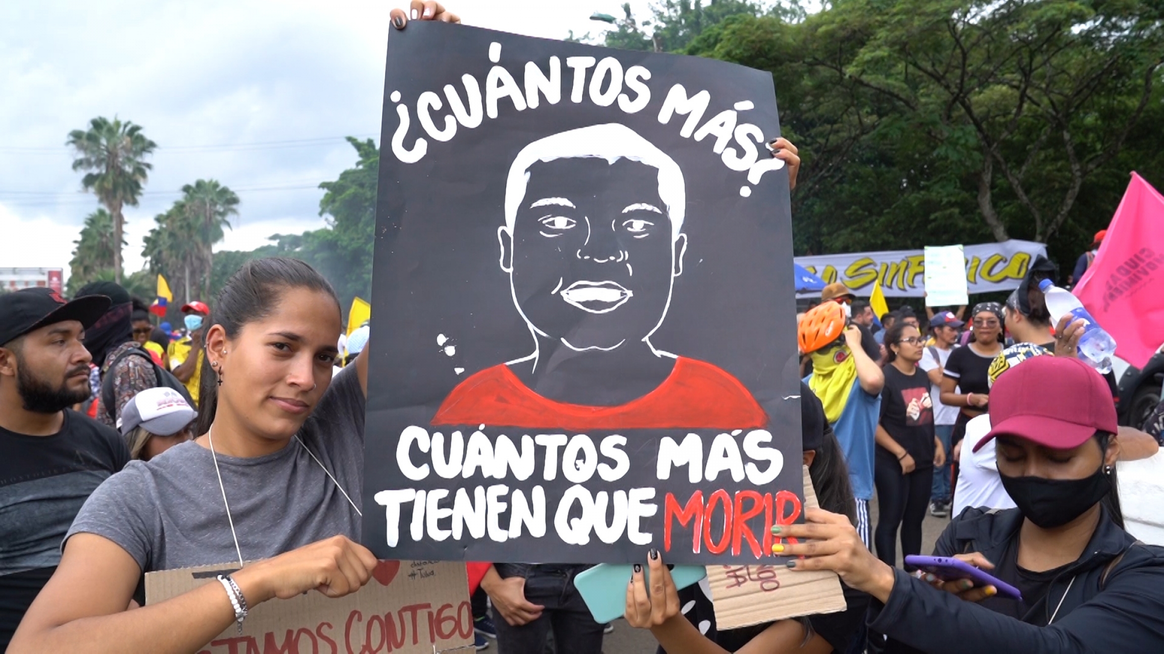 A poster that says, "how many more must die?" is displayed during a protest in Cali on May 28. A poster that says, "how many more must die?" is displayed during a protest in Cali on May 28.