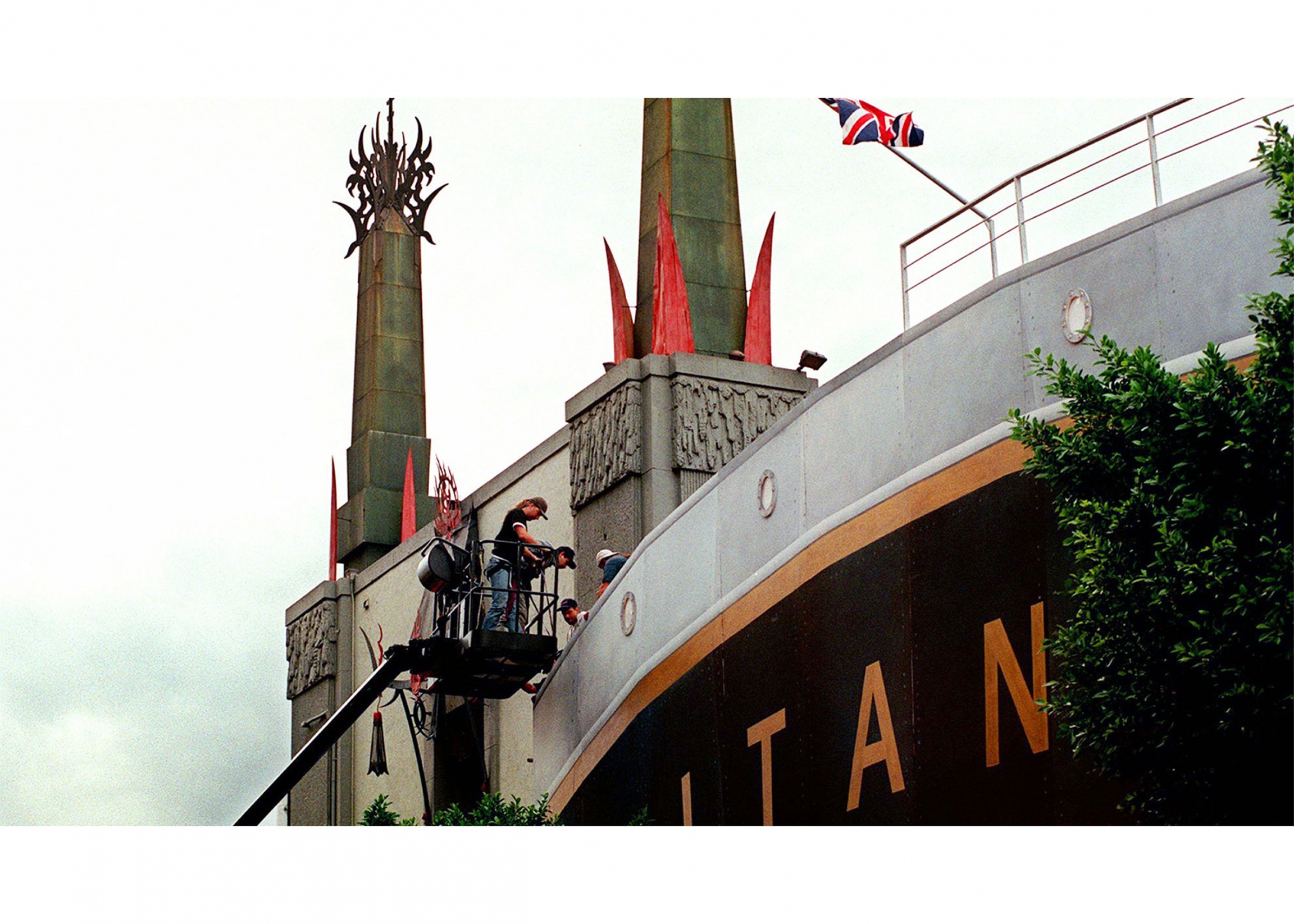 Workmen put the finishing touches on a facade outside Mann's Chinese Theater People working on a replica display of the Titanic