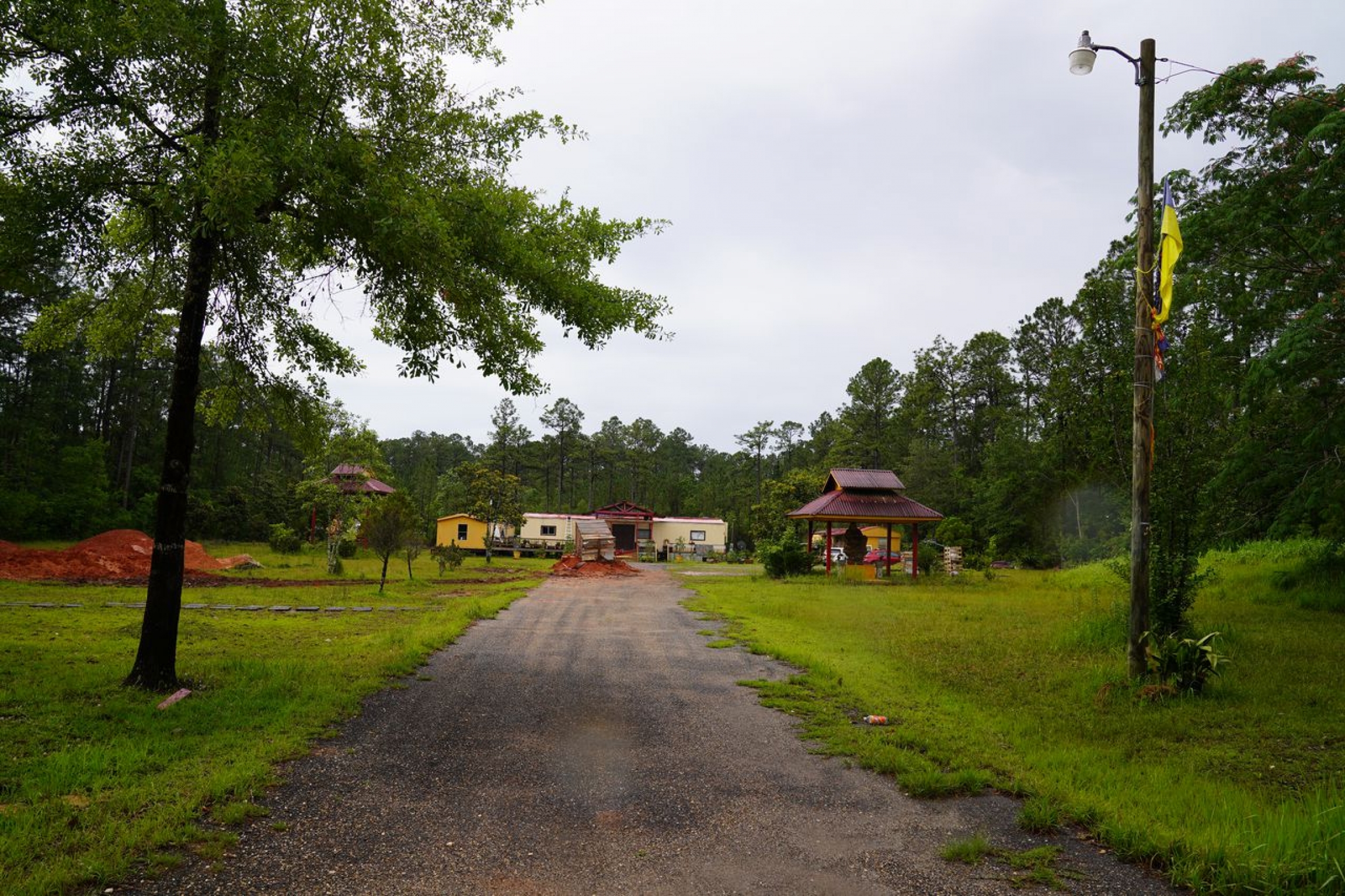 Le's Buddhist temple in Bayou La Batre A temple in the distance between green lawns and trees