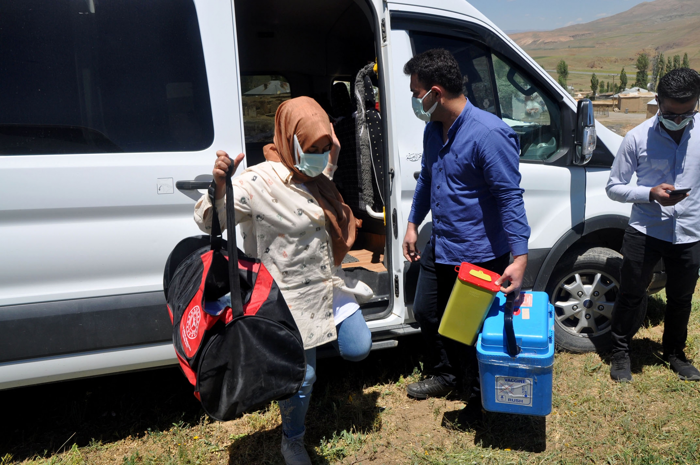 Health workers unload equipment to give out COVID vaccines in Ömerova, a village in Turkey’s eastern Kurdish region. Health workers unload equipment to give out COVID vaccines in Ömerova, a village in Turkey’s eastern Kurdish region.