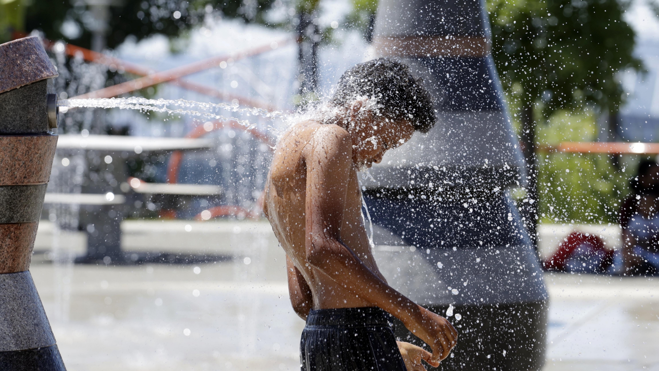 A young person cools off in the Yesler Terrace spray park during a heat wave hitting the Pacific Northwest, Sunday, June 27, 2021, in Seattle. Yesterday set a record high for the day with more record highs expected today and Monday. A young person cools off in the Yesler Terrace spray park during a heat wave hitting the Pacific Northwest, Sunday, June 27, 2021, in Seattle.