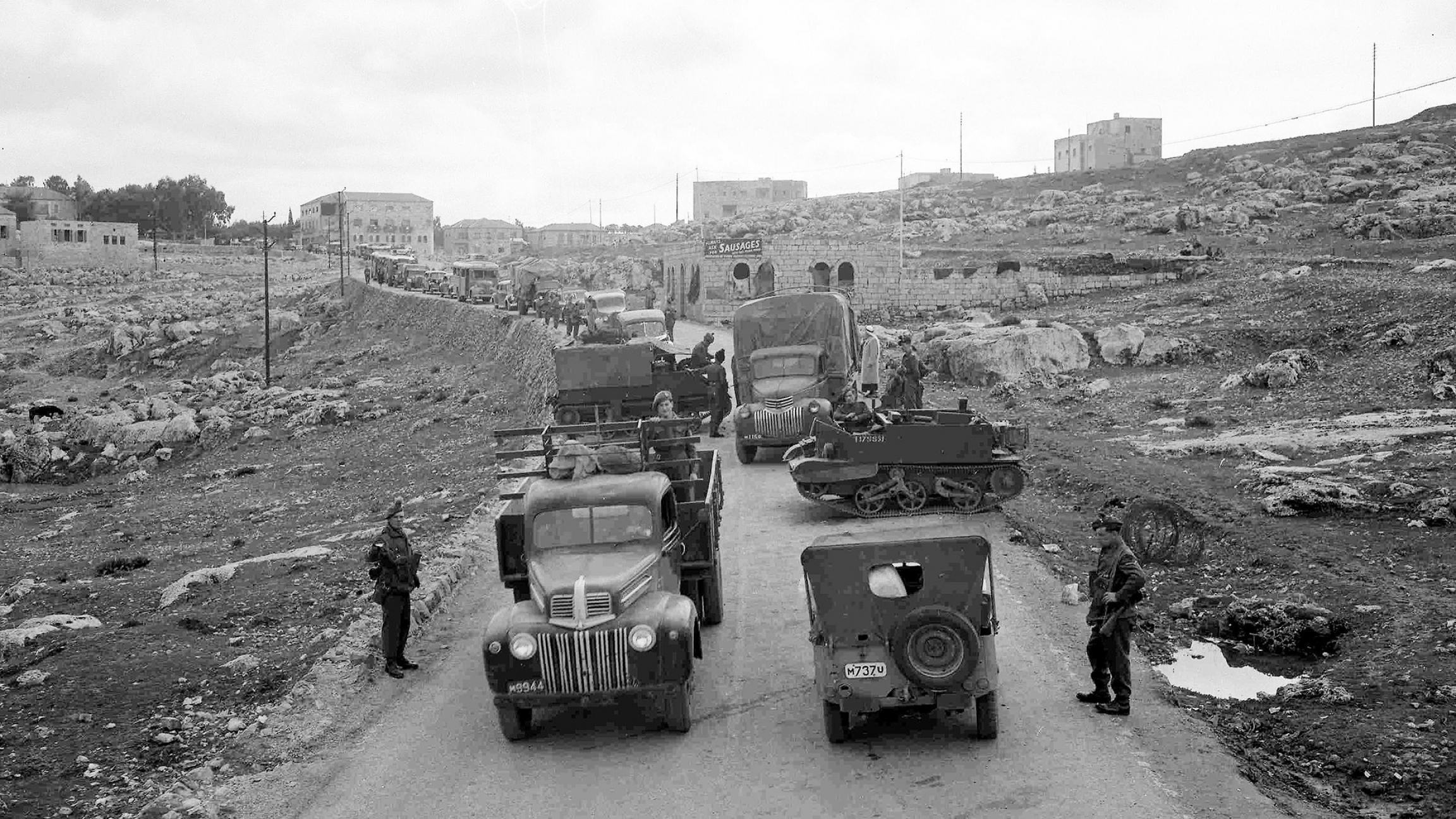 A line of vehicles, stretching for almost a mile, waits to pass through a road block on the main road from Jerusalem to Tel Aviv, Feb. 6, 1947. The road block is manned by members of the Royal Irish Fusiliers. A line of vehicles, stretching for almost a mile, waits to pass through a road block on the main road from Jerusalem to Tel Aviv, Feb. 6, 1947. The road block is manned by members of the Royal Irish Fusiliers.