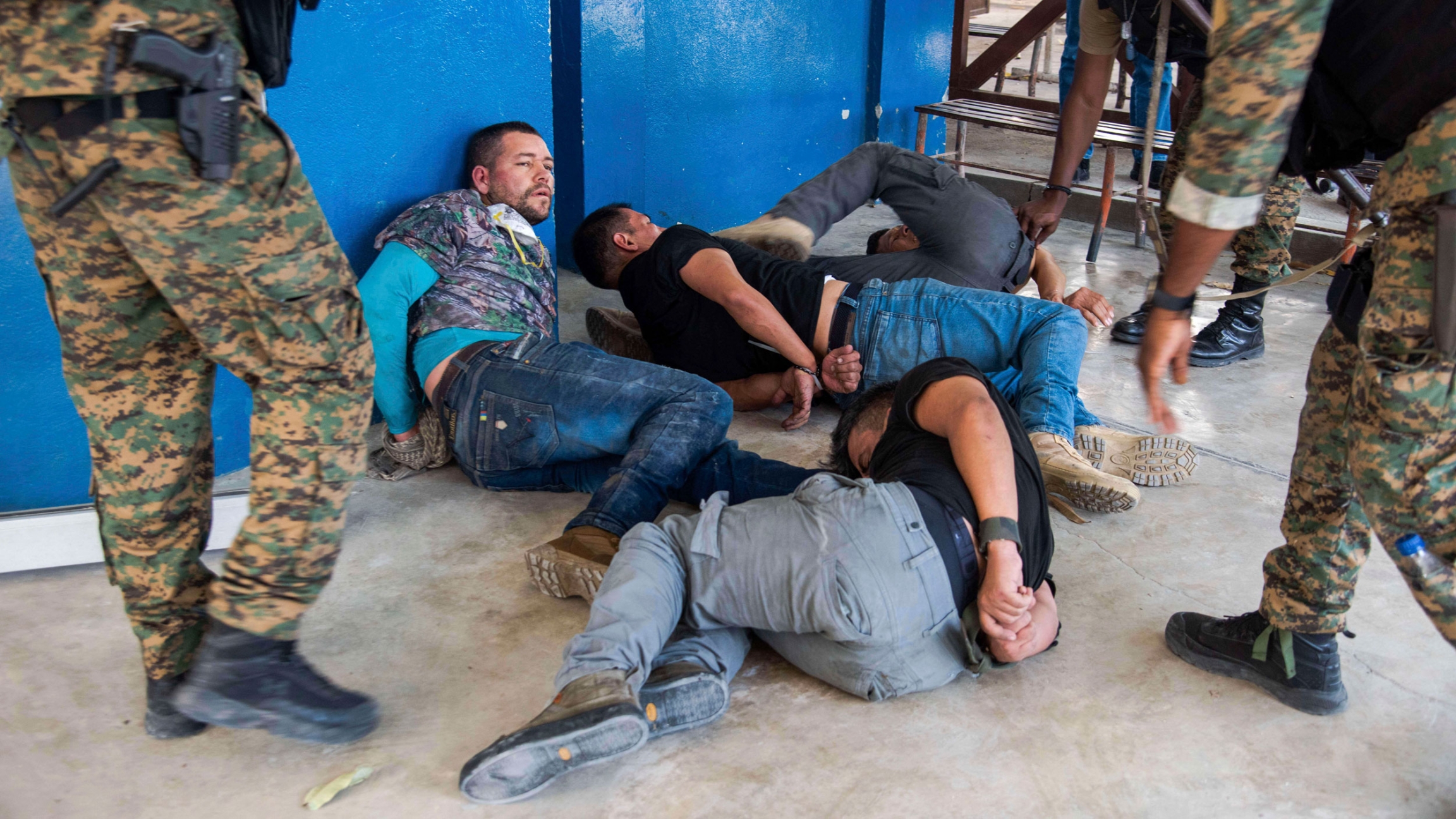 Suspects in the assassination of Haiti's President Jovenel Moïse are tossed on the floor after being detained, at the General Direction of the police in Port-au-Prince, Haiti, Thursday, July 8, 2021. Suspects in the assassination of Haiti's President Jovenel Moïse are tossed on the floor after being detained.