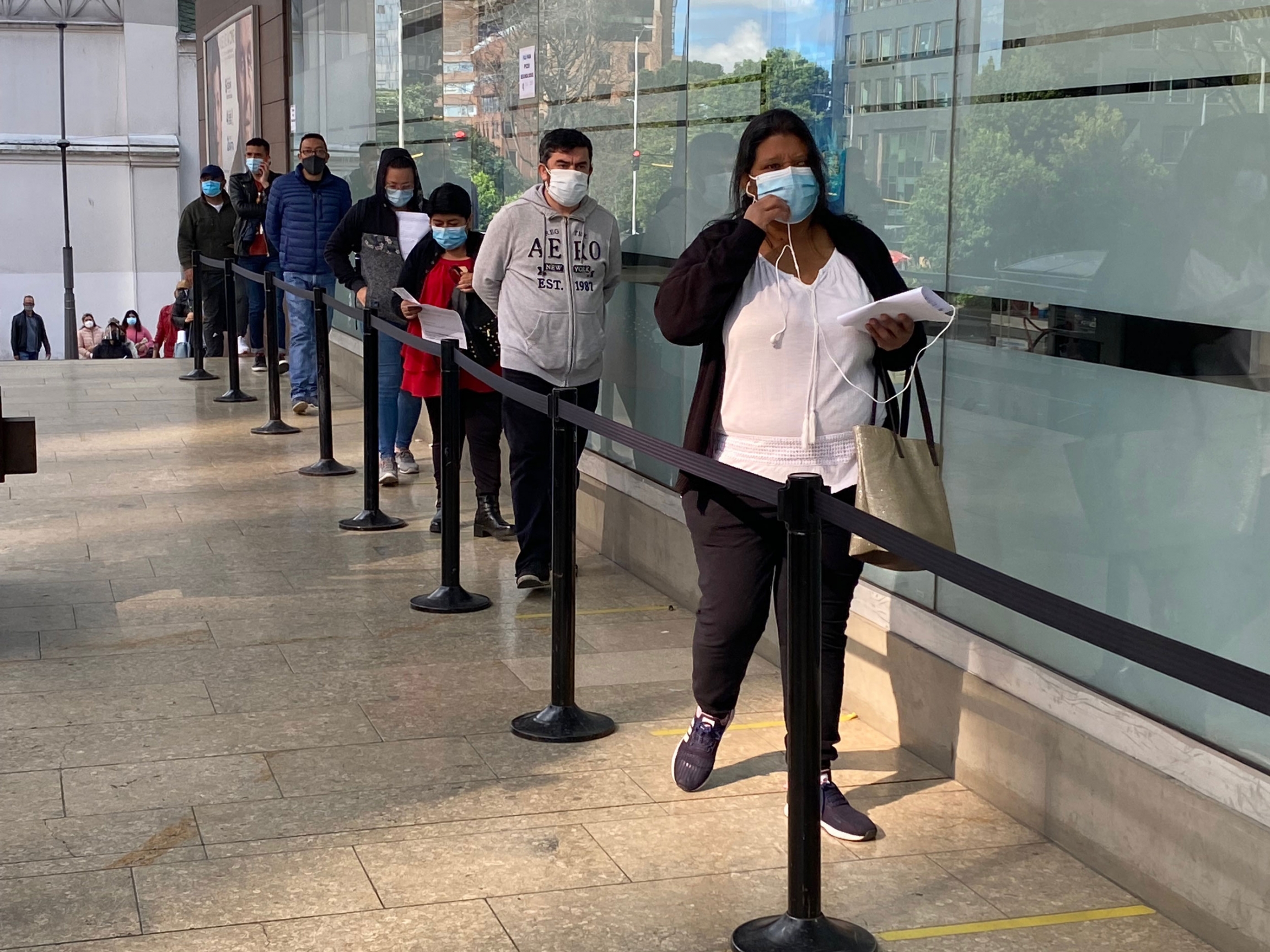People line up for vaccines outside a shopping mall in Bogotá, Colombia, on July 3. Vaccines are still scarce in Colombia, so only people over 40, or those with serious illnesses, are currently eligible for vaccines sponsored by the government. People line up to receive a vaccine.