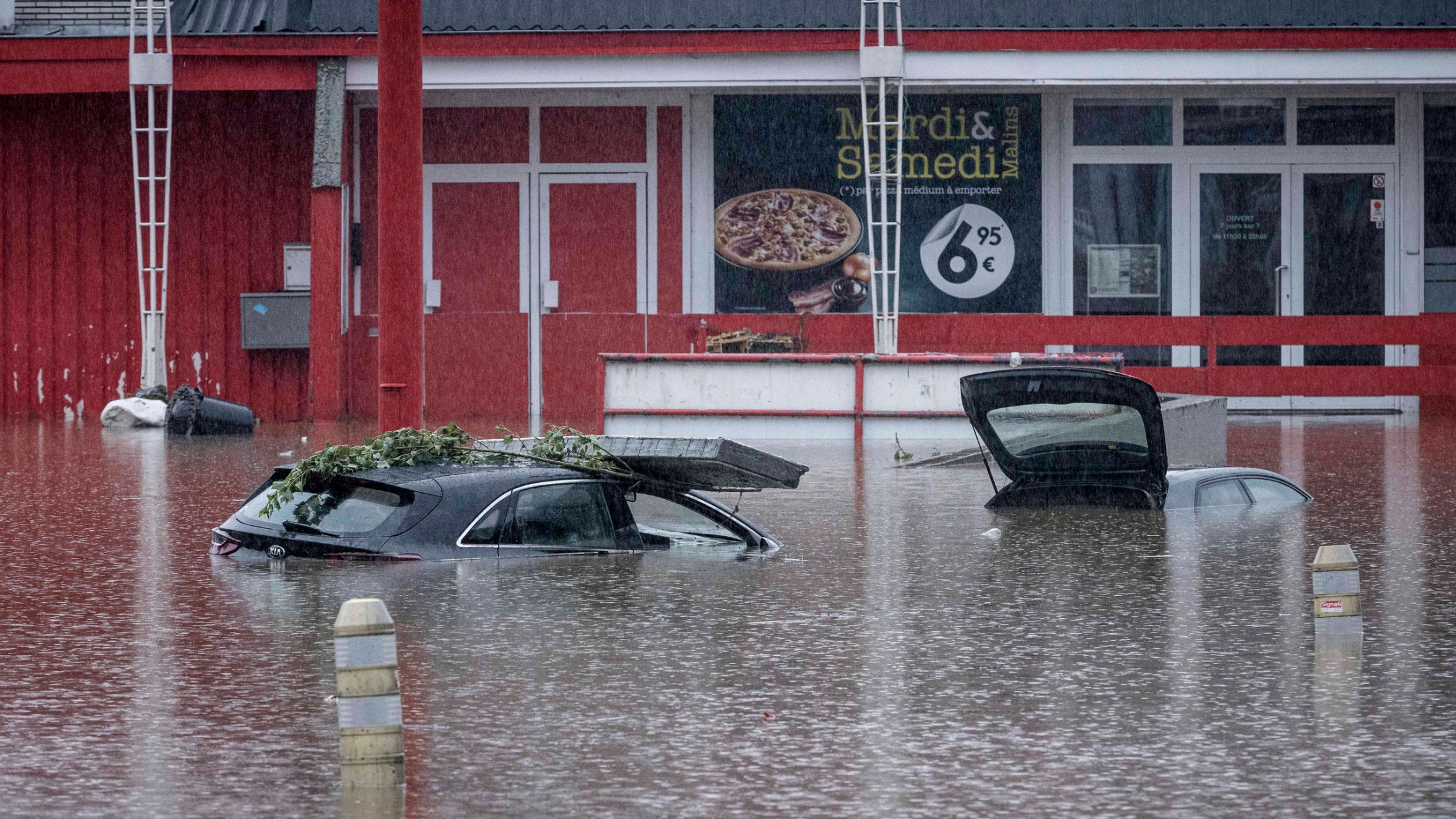 Cars are submerged in water after the Meuse River broke its banks during heavy flooding in Liege, Belgium, Thursday, July 15, 2021. Cars are submerged in water after the Meuse River broke its banks during heavy flooding in Liege, Belgium, Thursday, July 15, 2021.