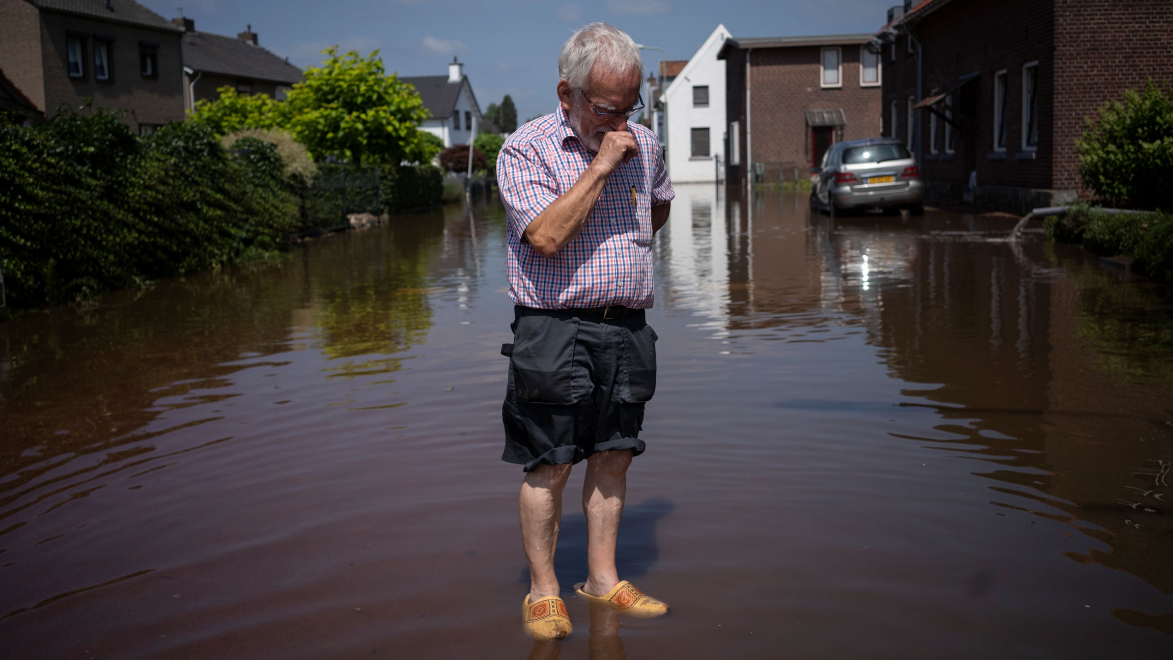 Wiel de Bie, 75, stands outside his flooded home in the town of Brommelen, Netherlands, July 17, 2021. Wiel de Bie, 75, stands outside his flooded home in the town of Brommelen, Netherlands, July 17, 2021.