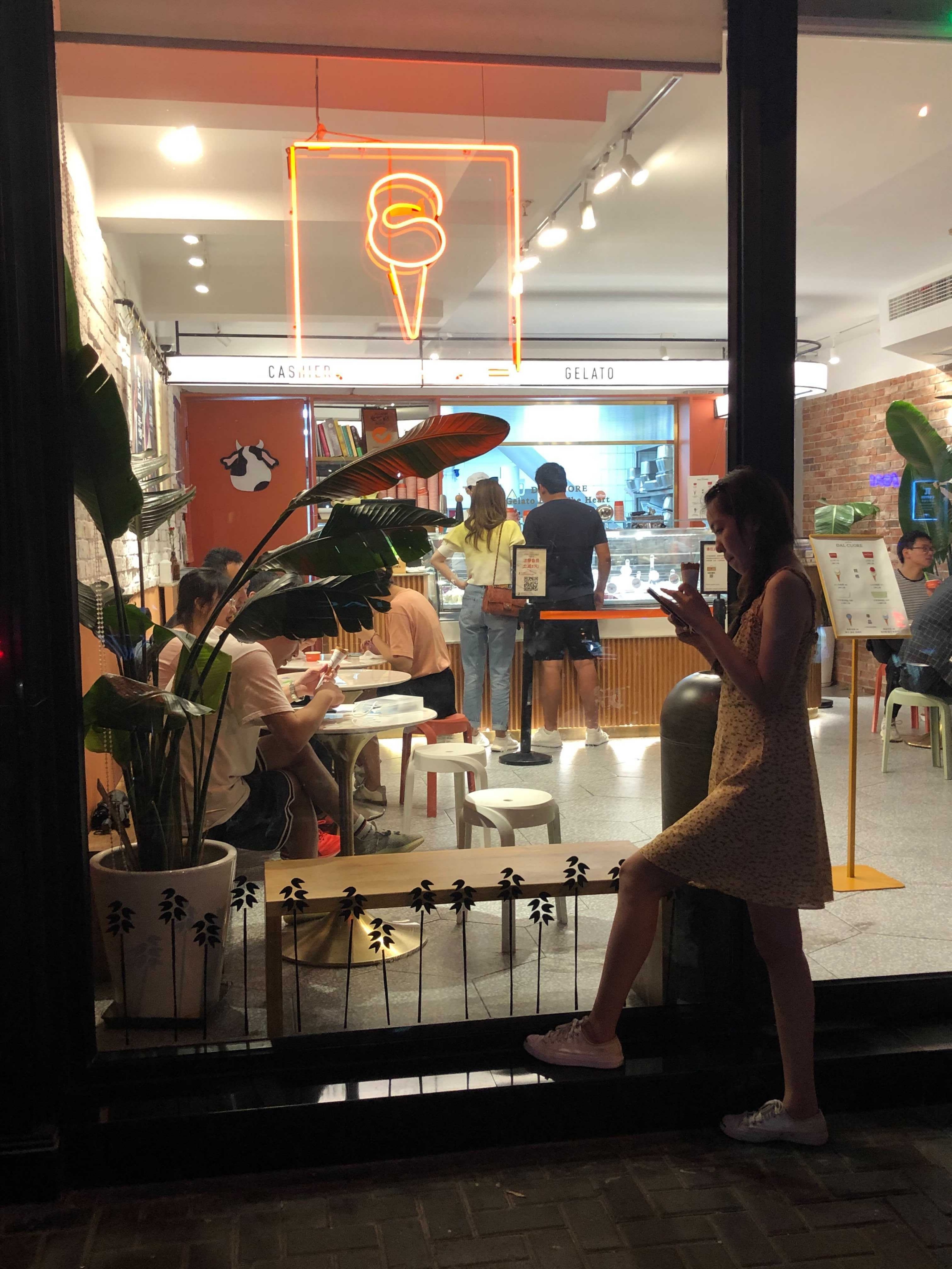 China experiments with ice cream flavors Woman stands outside Gelato Dal Cuore ice cream shop and customers order inside