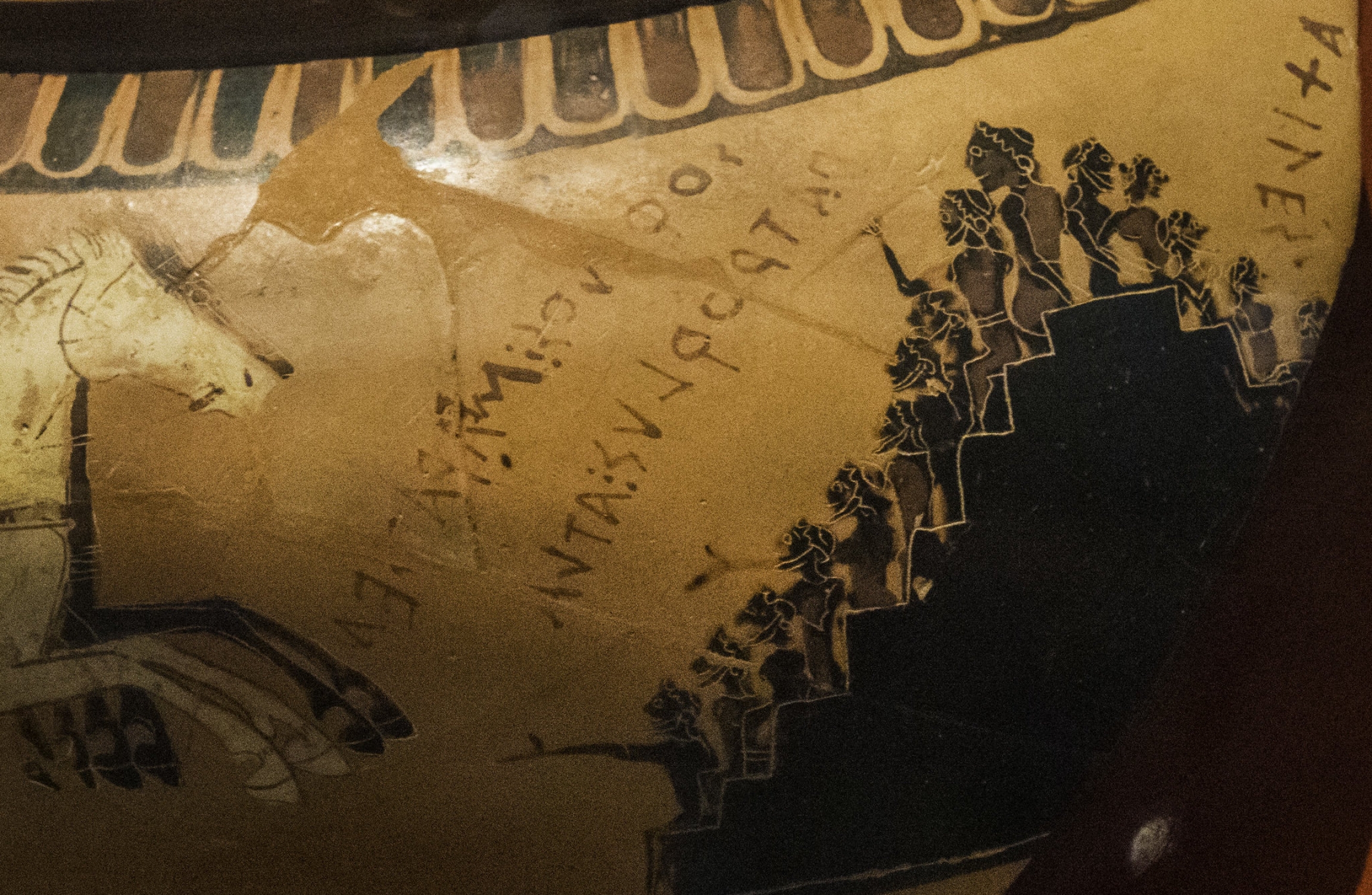 A detail of a Greek cauldron depicts spectators cheering on a chariot race. A detail of a Greek cauldron depicts spectators cheering on a chariot race.