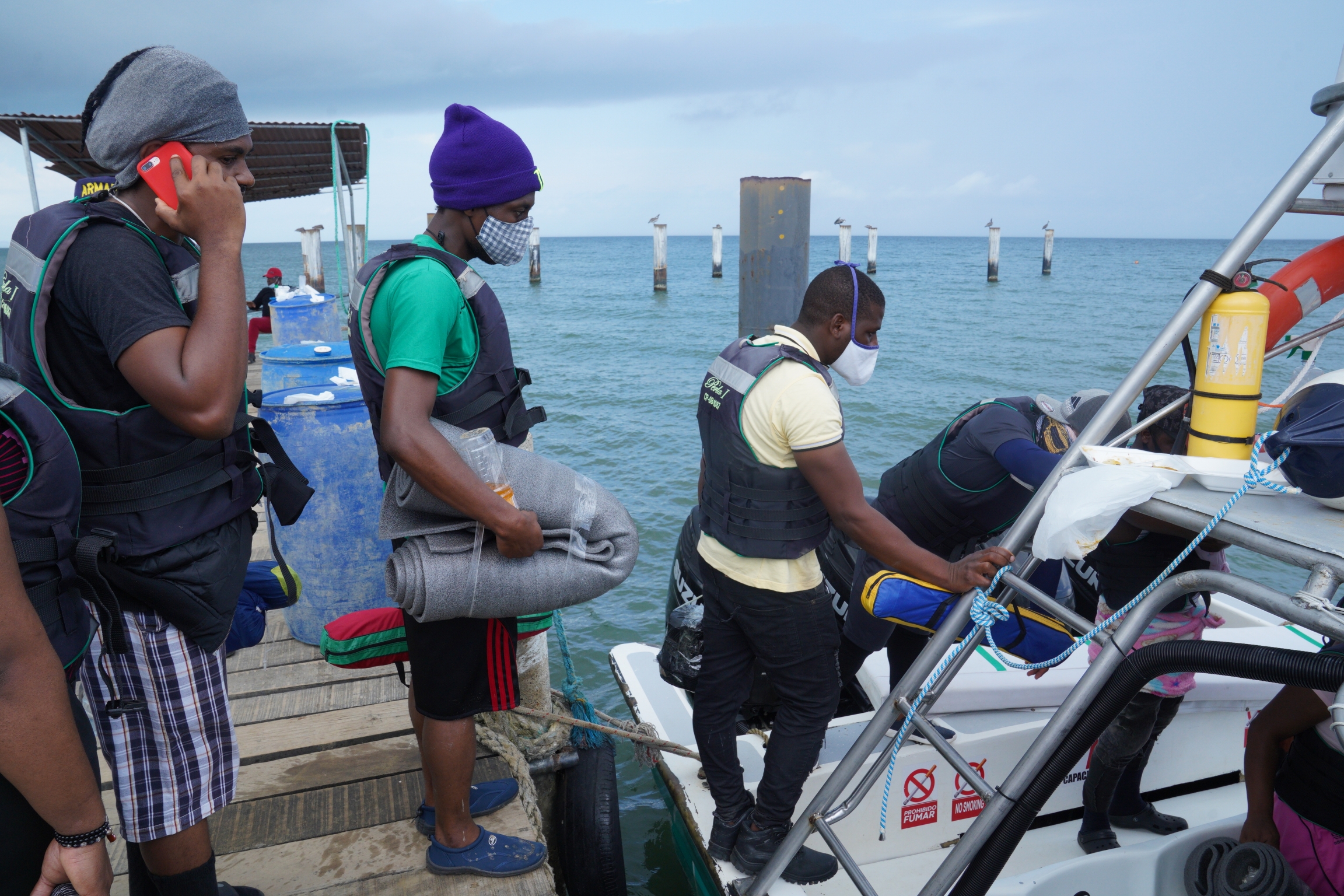 A group of Haitian migrants boards a boat that will take them from Necocli, Colombia to the village of Capurgana, where the trail through the Darien Gap begins. A group of Haitian migrants boards a boat that will take them from Necocli, Colombia to the village of Capurgana, where the trail through the Darien Gap begins.