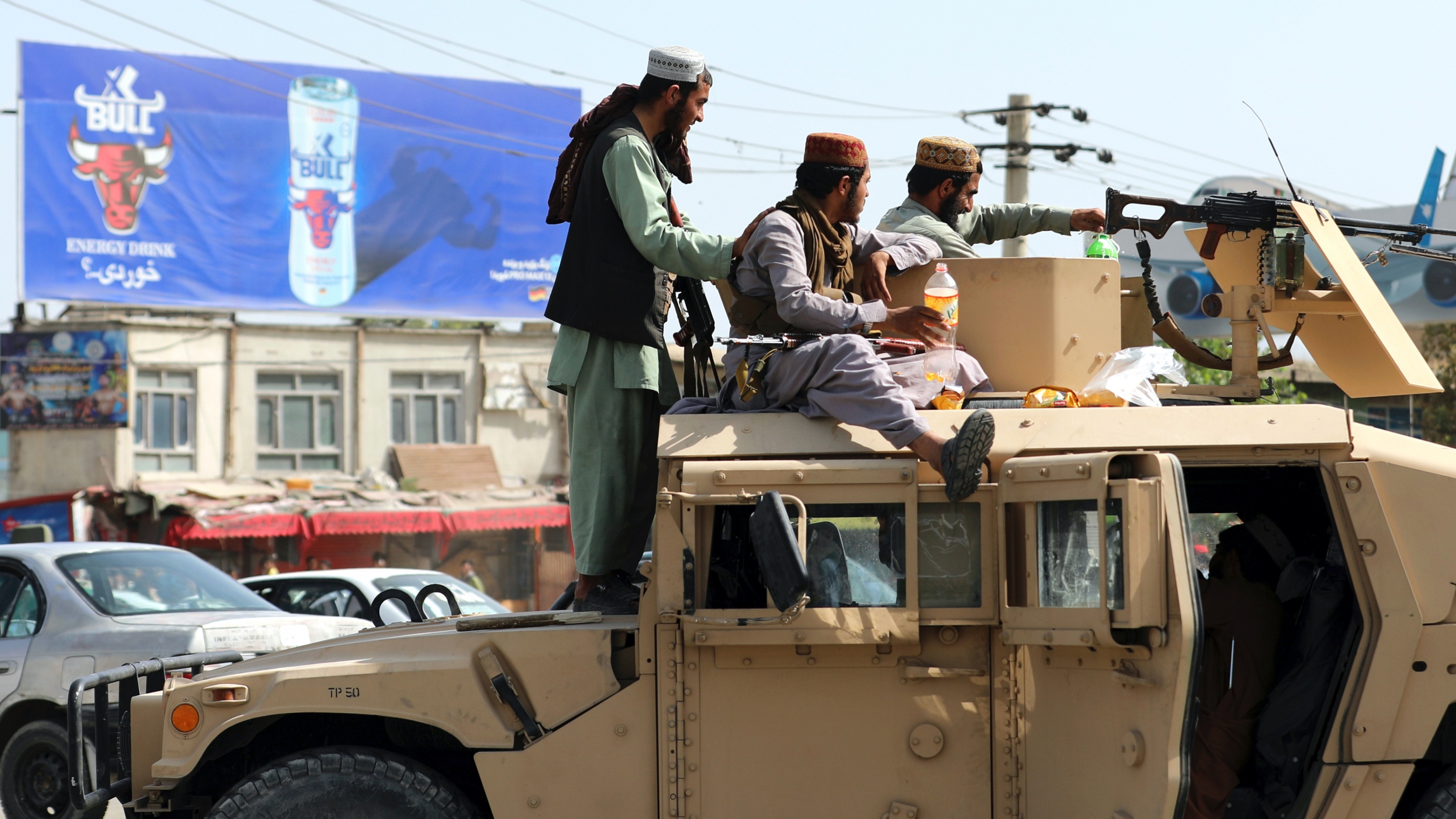 Taliban fighters stand guard in front of the Hamid Karzai International Airport, in Kabul, Afghanistan, Aug. 16, 2021. Taliban fighters stand guard in front of the Hamid Karzai International Airport, in Kabul, Afghanistan, Aug. 16, 2021.