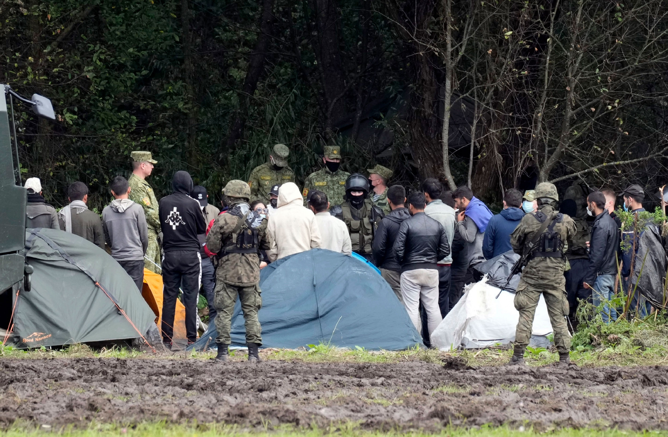 Polish security forces surround migrants stuck along with border with Belarus in Usnarz Gorny, Poland, on Wednesday, Sept. 1, 2021. Polish security forces surround migrants stuck along with border with Belarus in Usnarz Gorny, Poland, on Wednesday, Sept. 1, 2021.