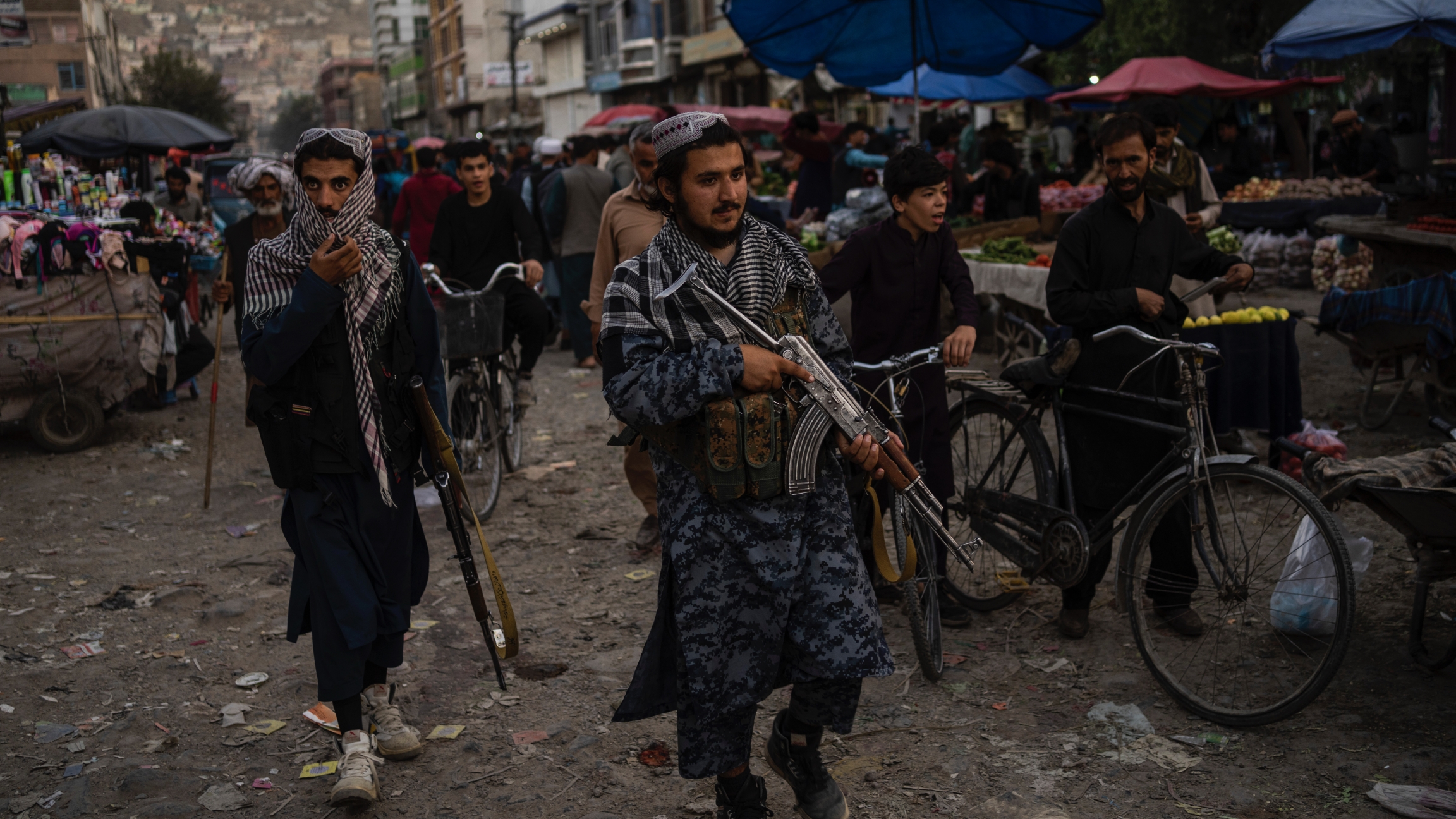 Taliban fighters patrol a market in Kabul's Old City, Afghanistan, Sept. 14, 2021. Taliban fighters patrol a market in Kabul's Old City, Afghanistan, Sept. 14, 2021.