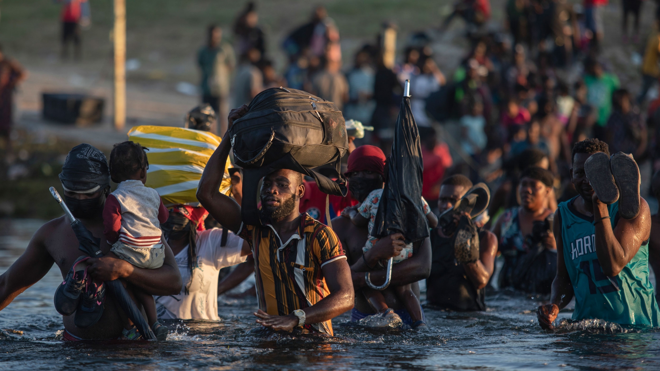 Migrants, many from Haiti, wade across the Rio Grande river from Del Rio, Texas, to return to Ciudad Acuña, Mexico, Monday, Sept. 20, 2021, to avoid deportation from the US. Migrants, many from Haiti, wade across the Rio Grande river from Del Rio, Texas, to return to Ciudad Acuña, Mexico, Monday, Sept. 20, 2021, to avoid deportation from the US.