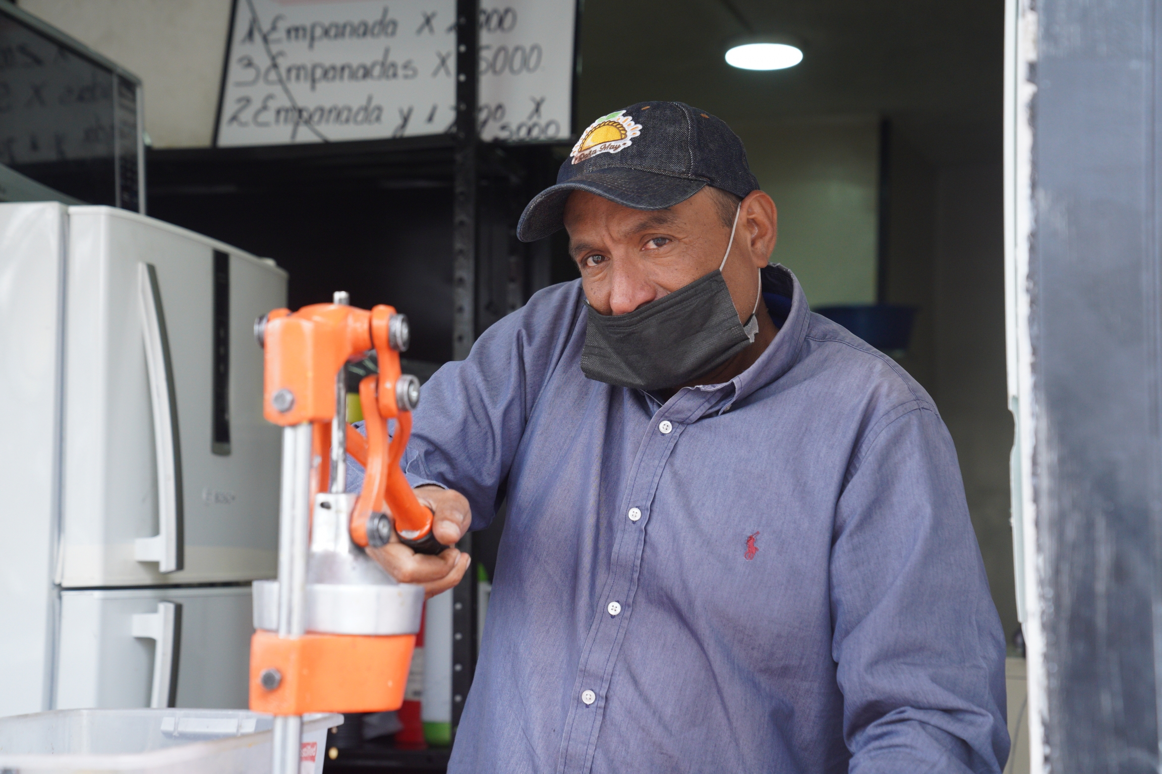 Angel Bruges sells empanadas and orange juice in Bogota. He says that he hasn't gotten vaccinated yet, because filling out his TPS application is complicated. Angel Bruges sells empanadas and orange juice in Bogota. He says that he hasn't gotten vaccinated yet, because filling out his TPS application is complicated.