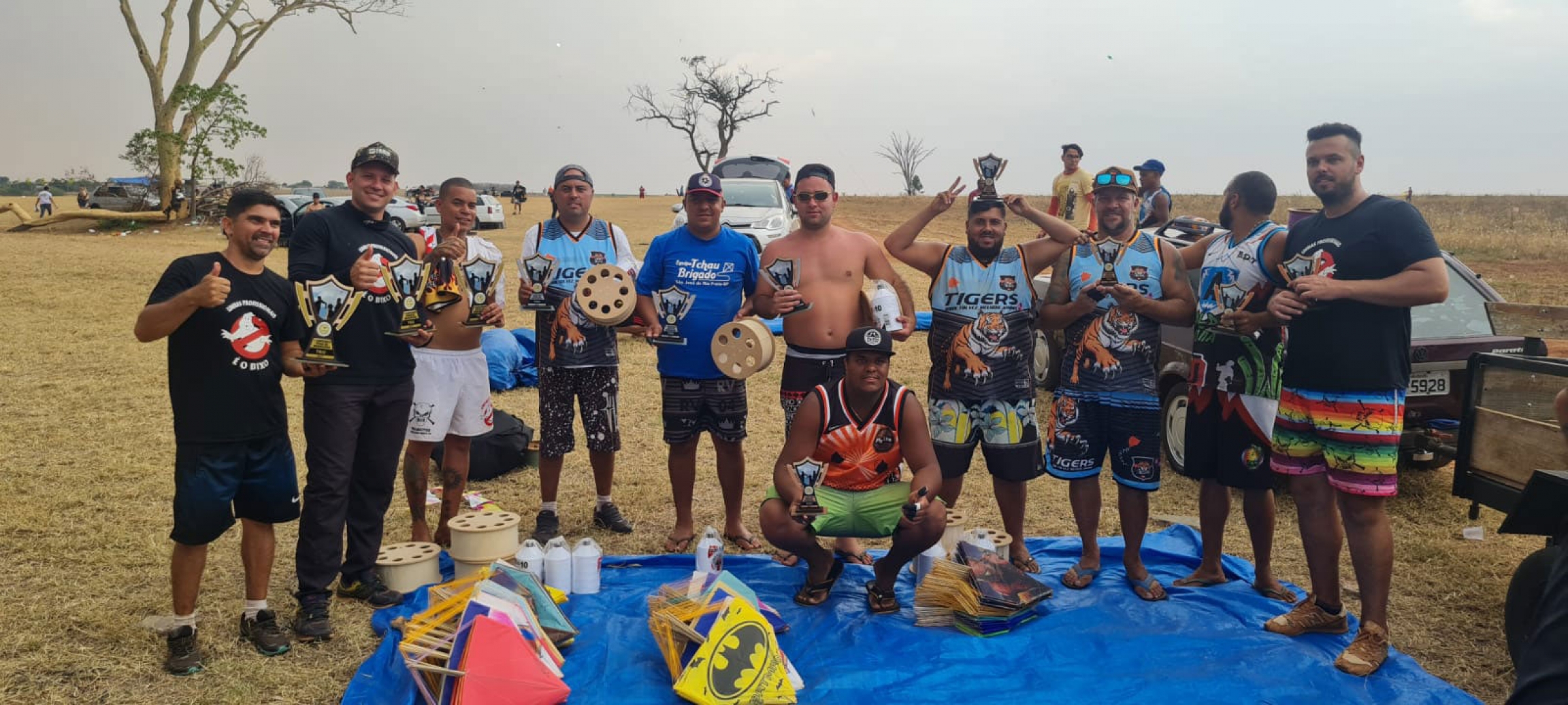 A group of older men pose after a kite-fighting competition. A group of older men pose after a kite-fighting competition.