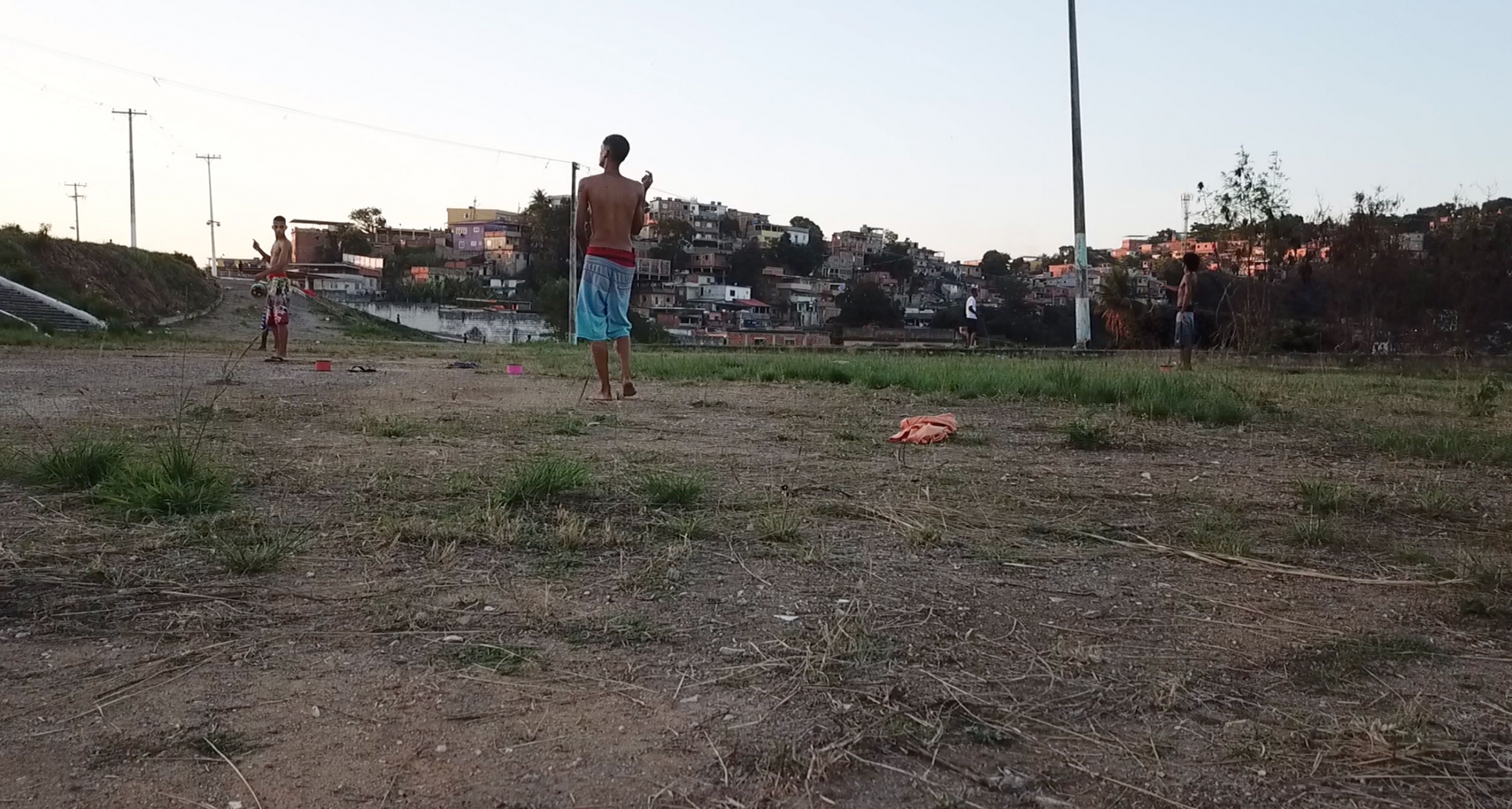 Teenage boys gather in an open field to fly kites in a Rio de Janeiro, Brazil. Teenage boys gather in an open field to fly kites.