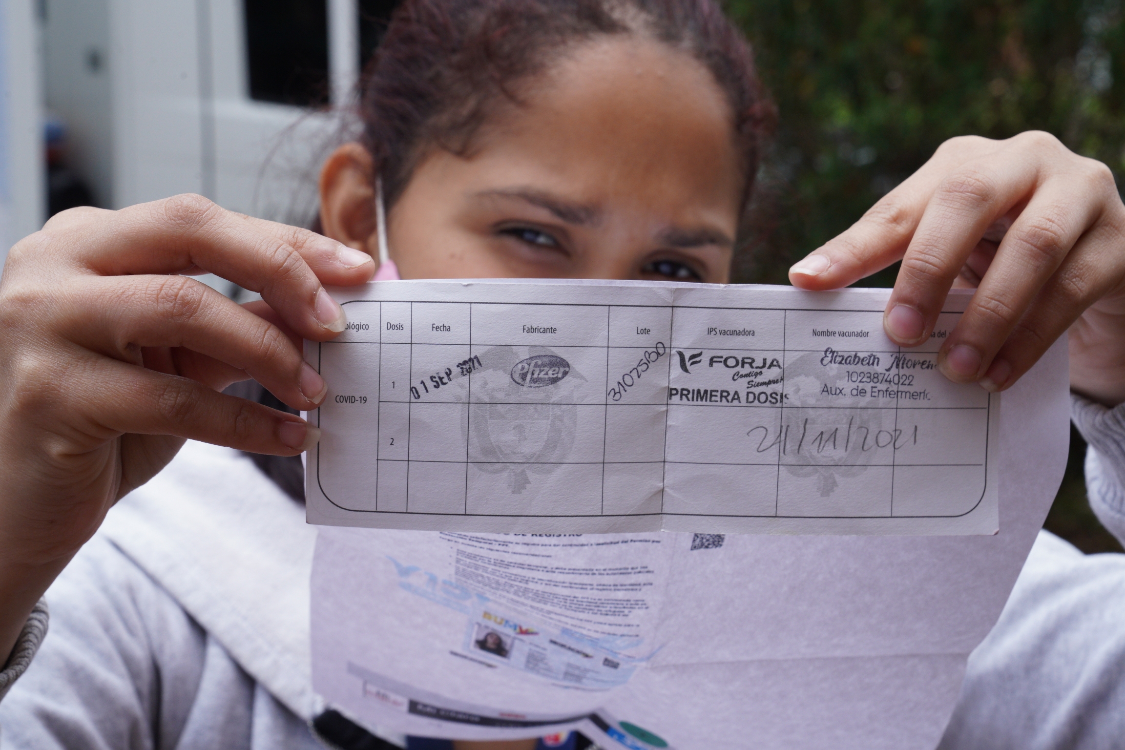 Oriana Fernandez Fernandez got her first dose of the Pfizer Vaccine in Bogota during the first week of September. But only after completing her TPS application and showing a sheet with a QR code that proved it. Oriana Fernandez Fernandez got her first dose of the Pfizer Vaccine in Bogota during the first week of September. But only after completing her TPS application and showing a sheet with a QR code that proved it.