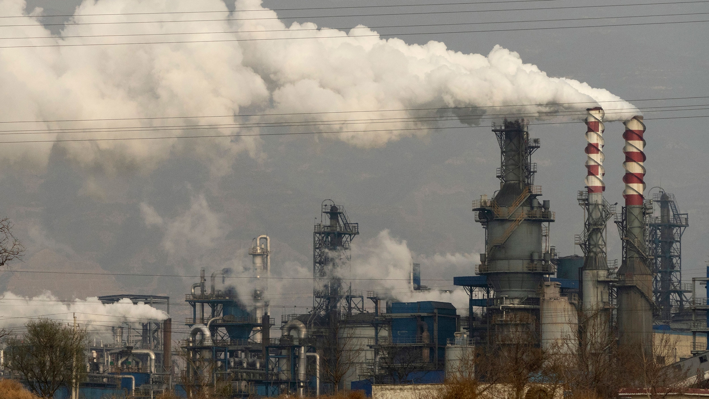 In this Nov. 28, 2019, file photo, smoke and steam rise from a coal processing plant in Hejin in central China's Shanxi Province. In this Nov. 28, 2019, file photo, smoke and steam rise from a coal processing plant in Hejin in central China's Shanxi Province.