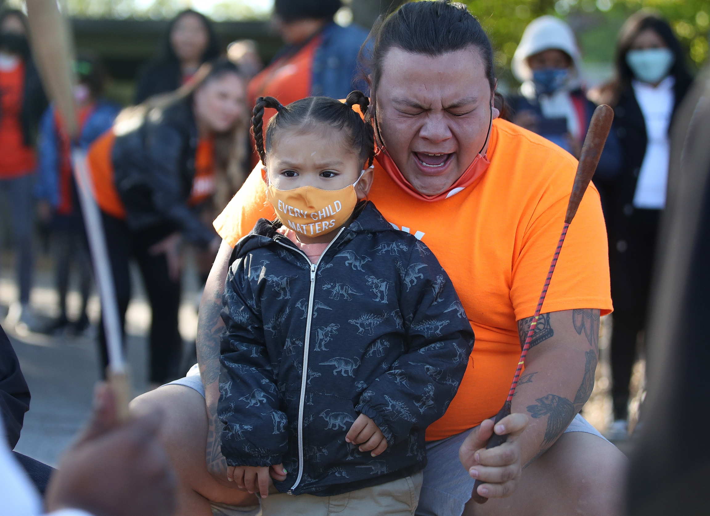 A child and adult with masks on
