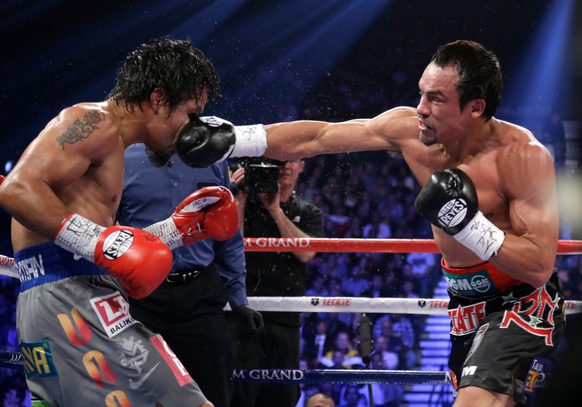 In this Dec. 8, 2012 file photo, Mexico's Juan Manuel Marquez lands a right to the head of Manny Pacquiao, from the Philippines, during their WBO world welterweight fight, in Las Vegas. In this Dec. 8, 2012 file photo, Mexico's Juan Manuel Marquez lands a right to the head of Manny Pacquiao, from the Philippines, during their WBO world welterweight fight, in Las Vegas.