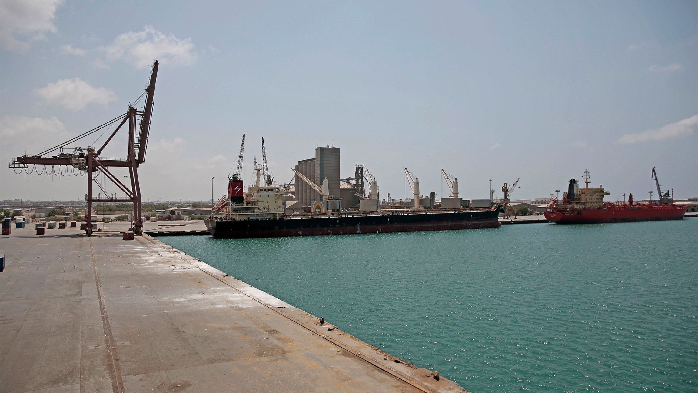 A cargo ship and oil tanker ship sit idle while docked at the port of Hodeida, Yemen A cargo ship and oil tanker ship sit idle while docked at the port of Hodeida, Yemen