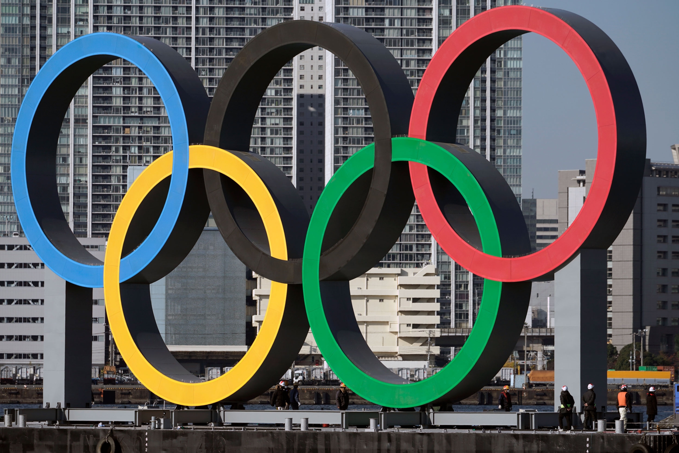 In this Dec. 1, 2020, file photo, the Olympic symbol is reinstalled after it was taken down for maintenance ahead of the postponed Tokyo 2020 Olympics. In this Dec. 1, 2020, file photo, the Olympic symbol is reinstalled after it was taken down for maintenance ahead of the postponed Tokyo 2020 Olympics.