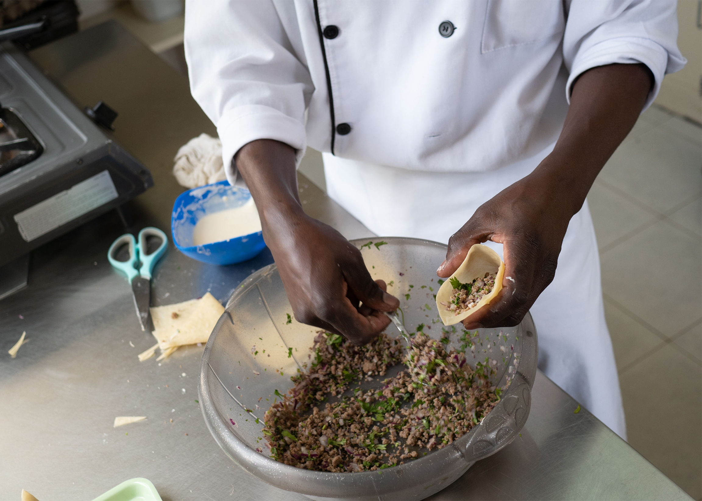 A Wau Eat employee fills mutton samosas, Nairobi, Kenya A Wau Eat employee fills mutton samosas, Nairobi, Kenya