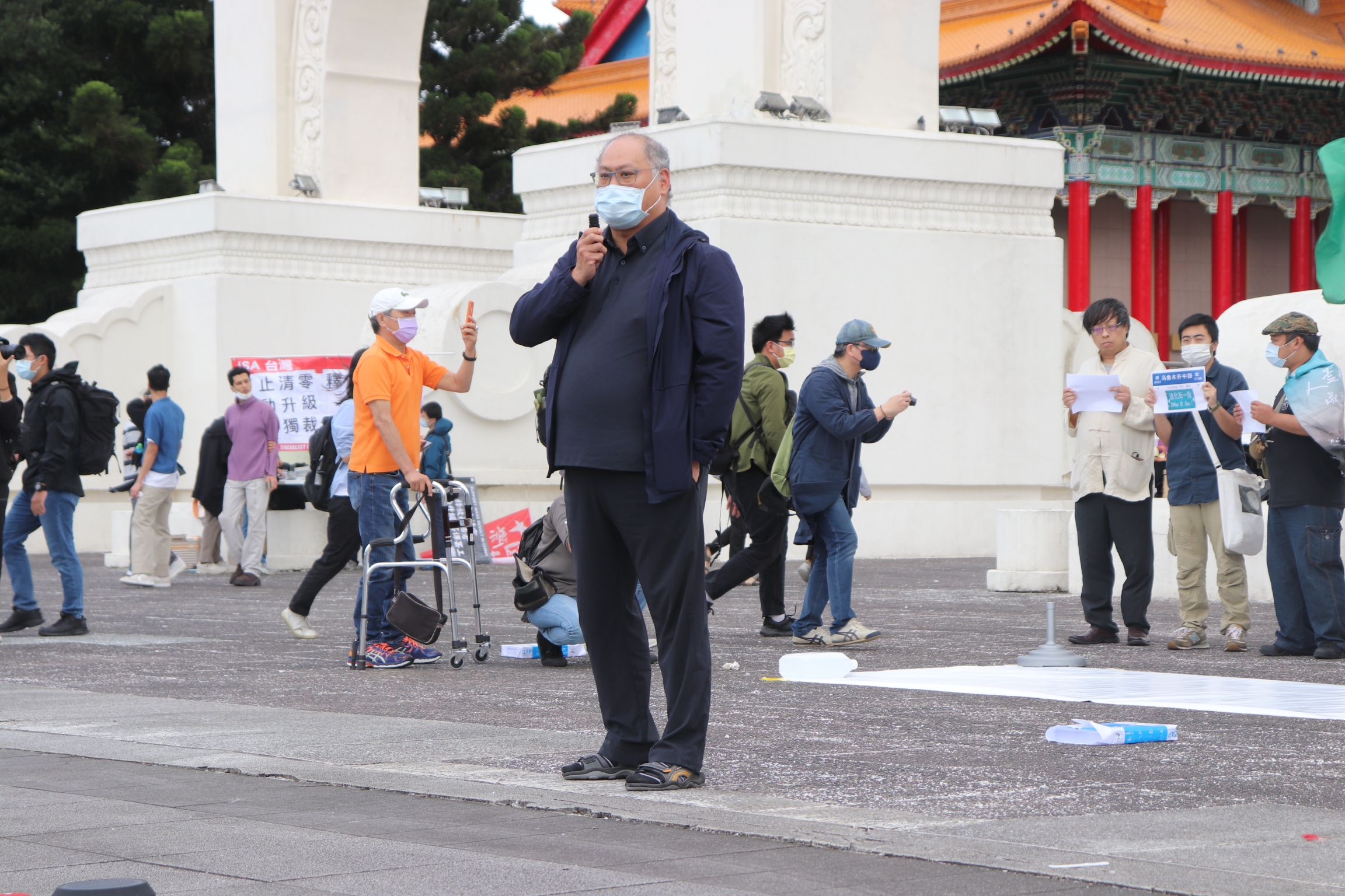 man speaking at rally