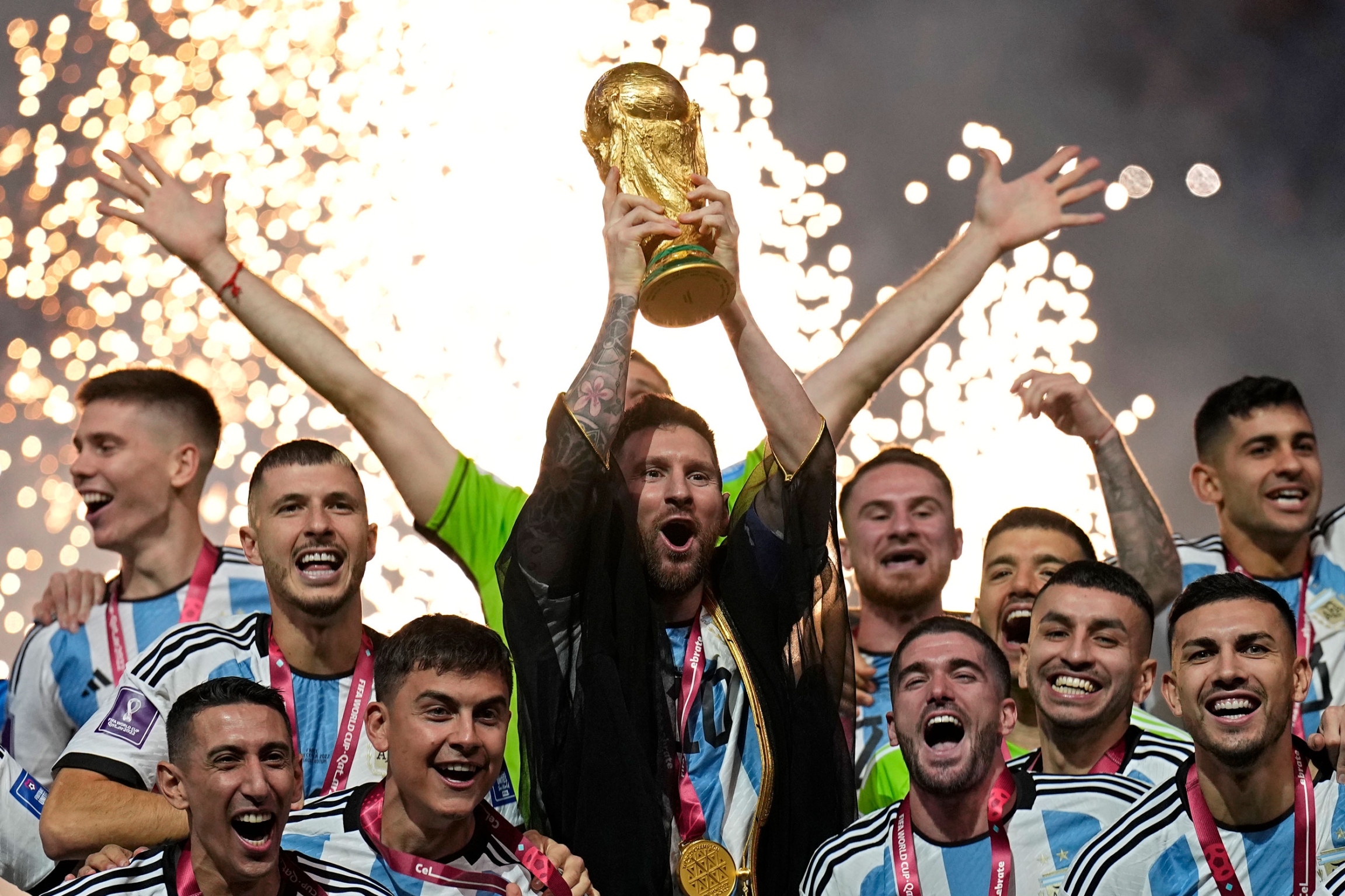 Argentina's Lionel Messi holds up the trophy after winning the World Cup final soccer match between Argentina and France at the Lusail Stadium in Lusail, Qatar, Sunday, Dec.18, 2022.