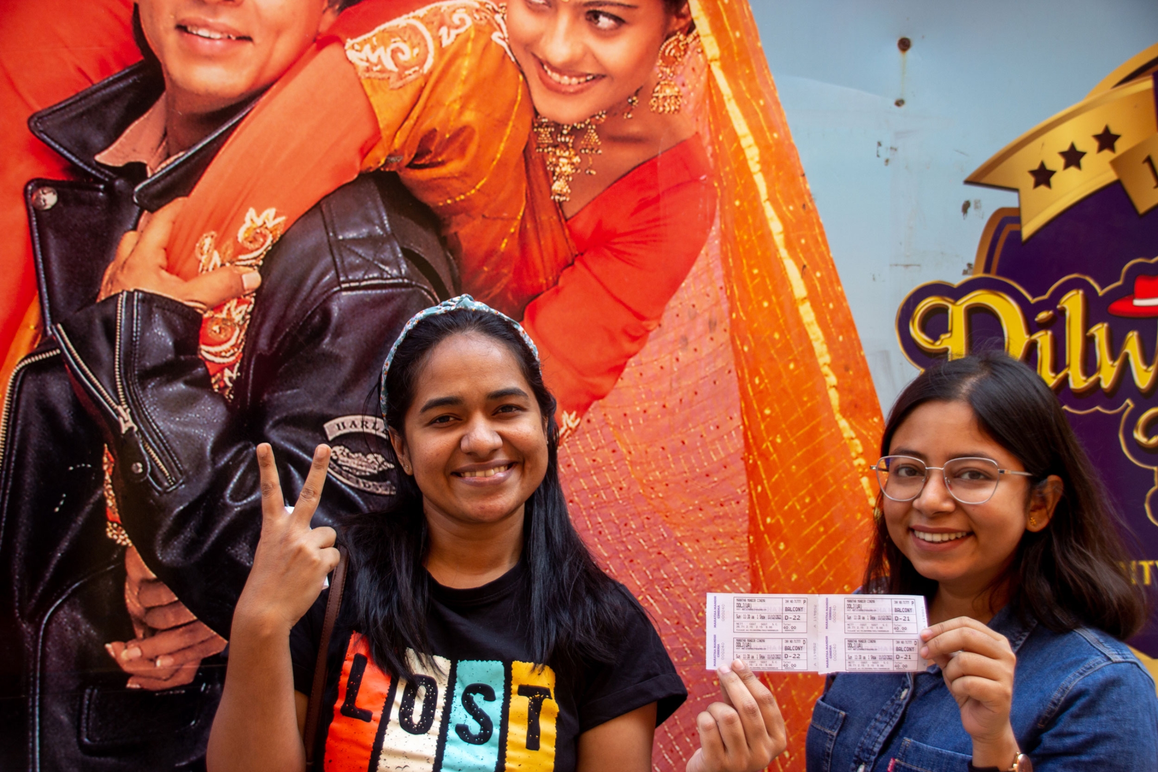 Two attendees show off their tickets. 