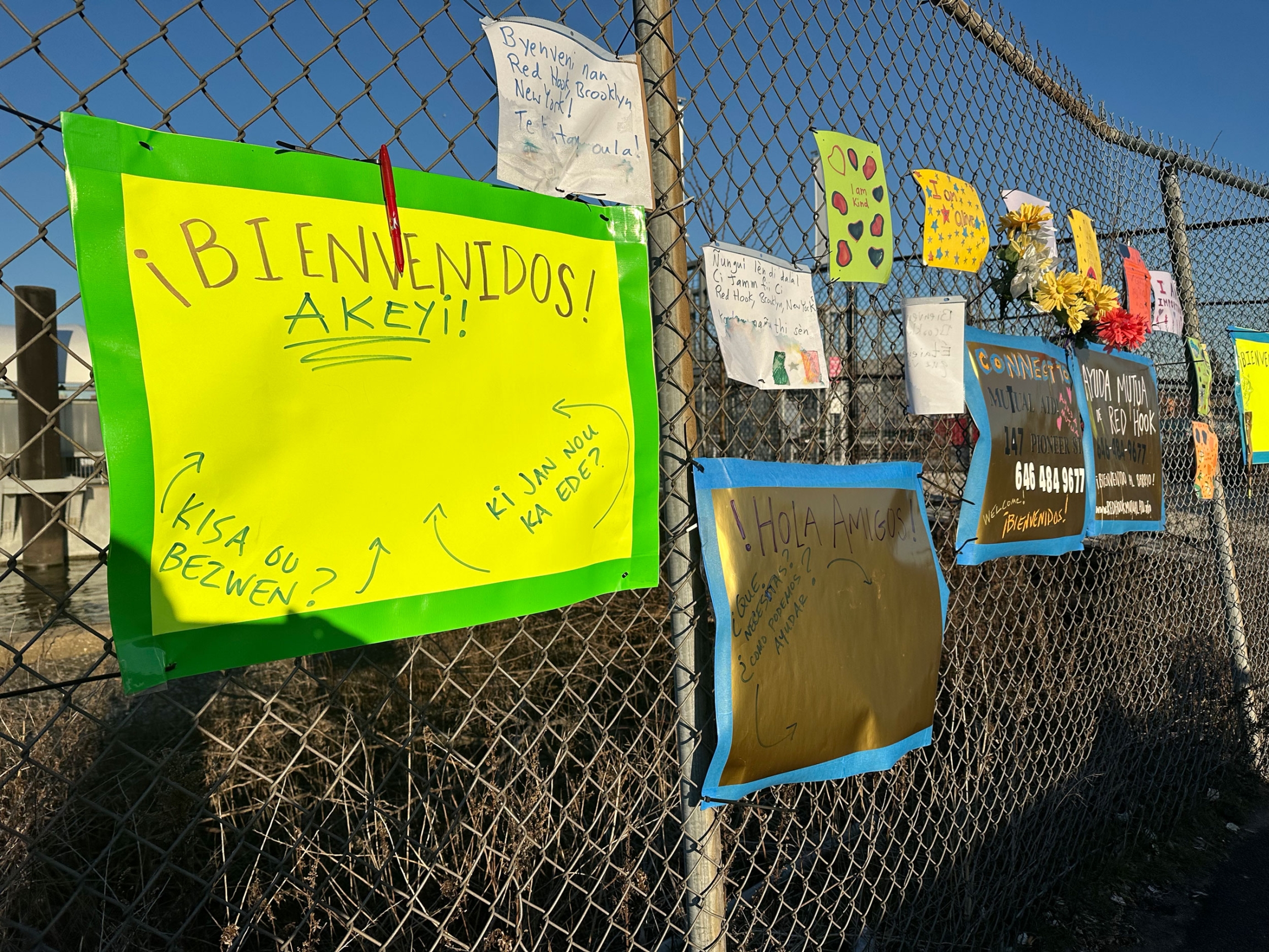 Residents of Brooklyn’s Red Hook neighborhood have placed welcoming signs in front of the cruise terminal reception center for migrants. 