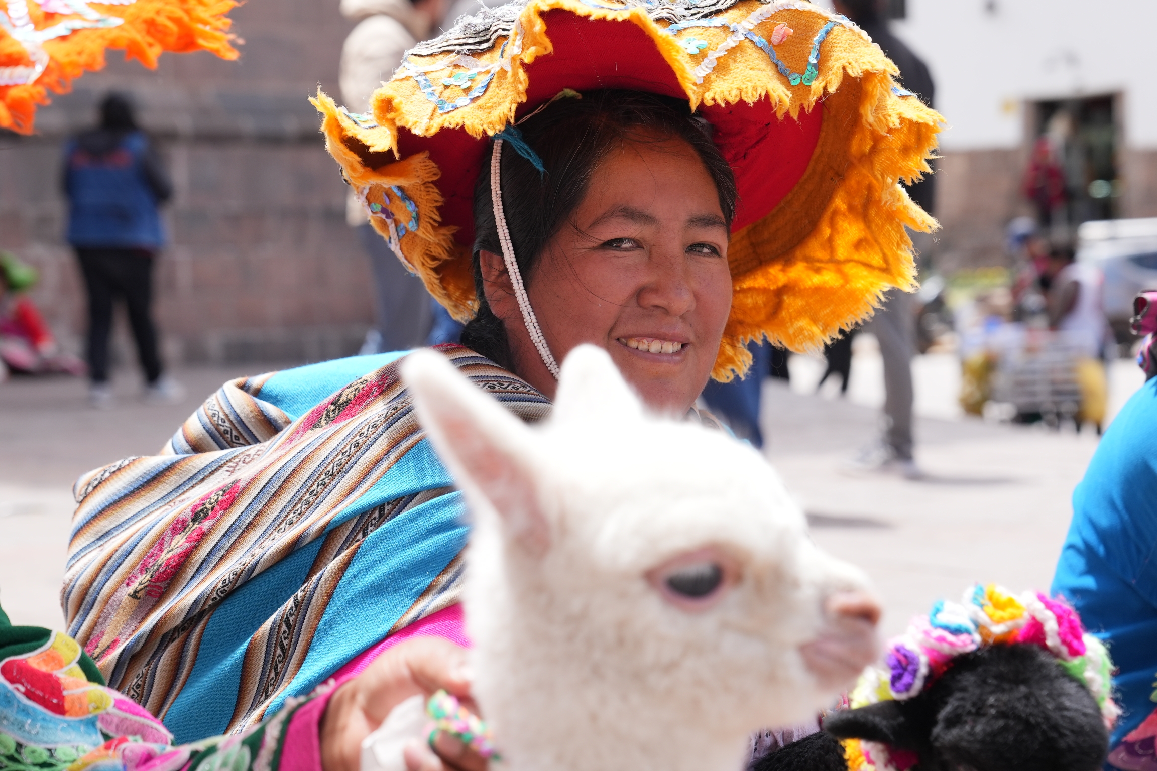 Dionisia Condori takes photos with tourists for tips. She said she supports the protests in Peru, but also wants a quick solution to the conflict.