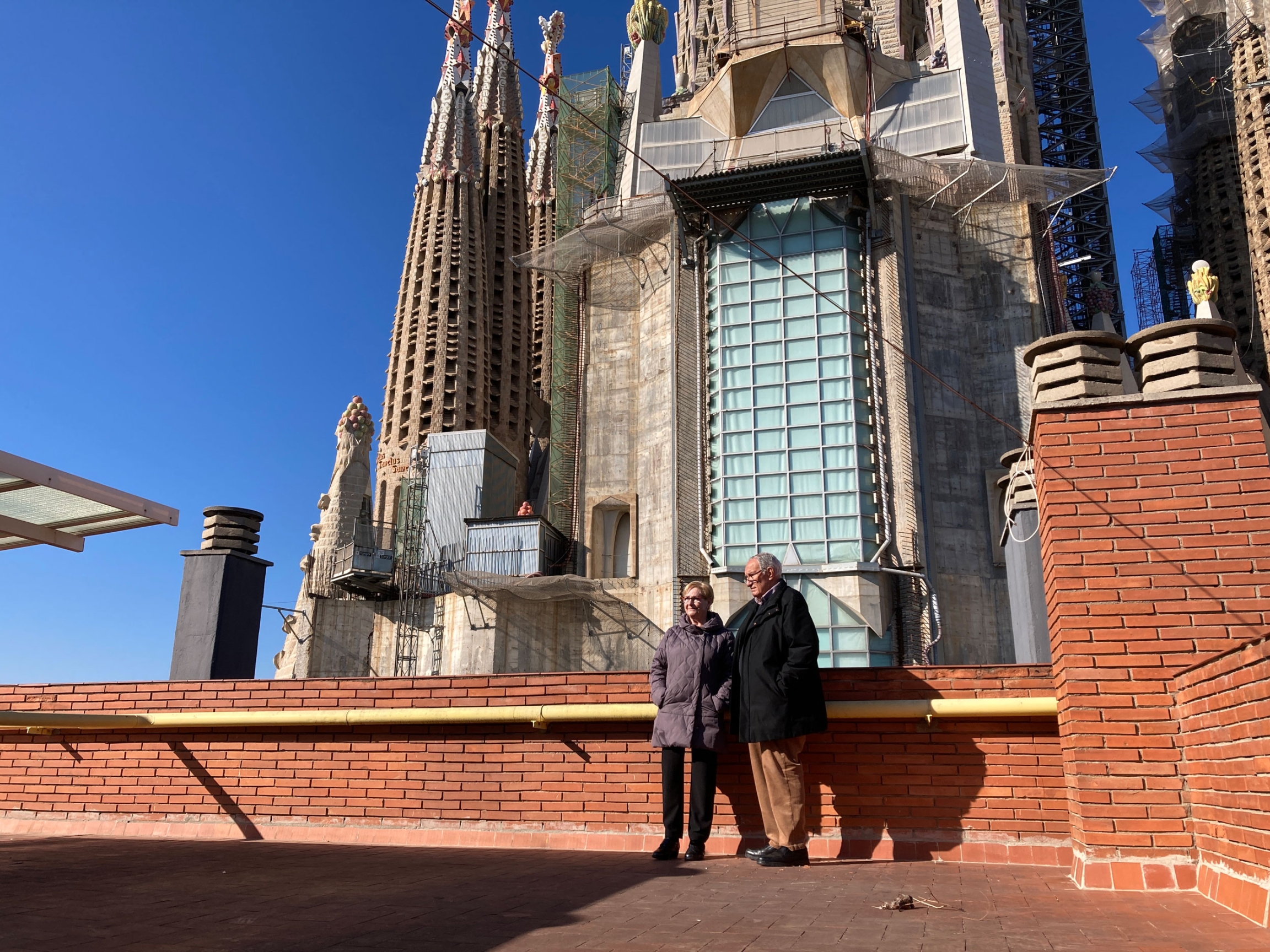 Maria Teresa Grevolosa, 77, and her husband, Albert Herrando, 81, stand on the rooftop of their apartment, right next to the basilica. 