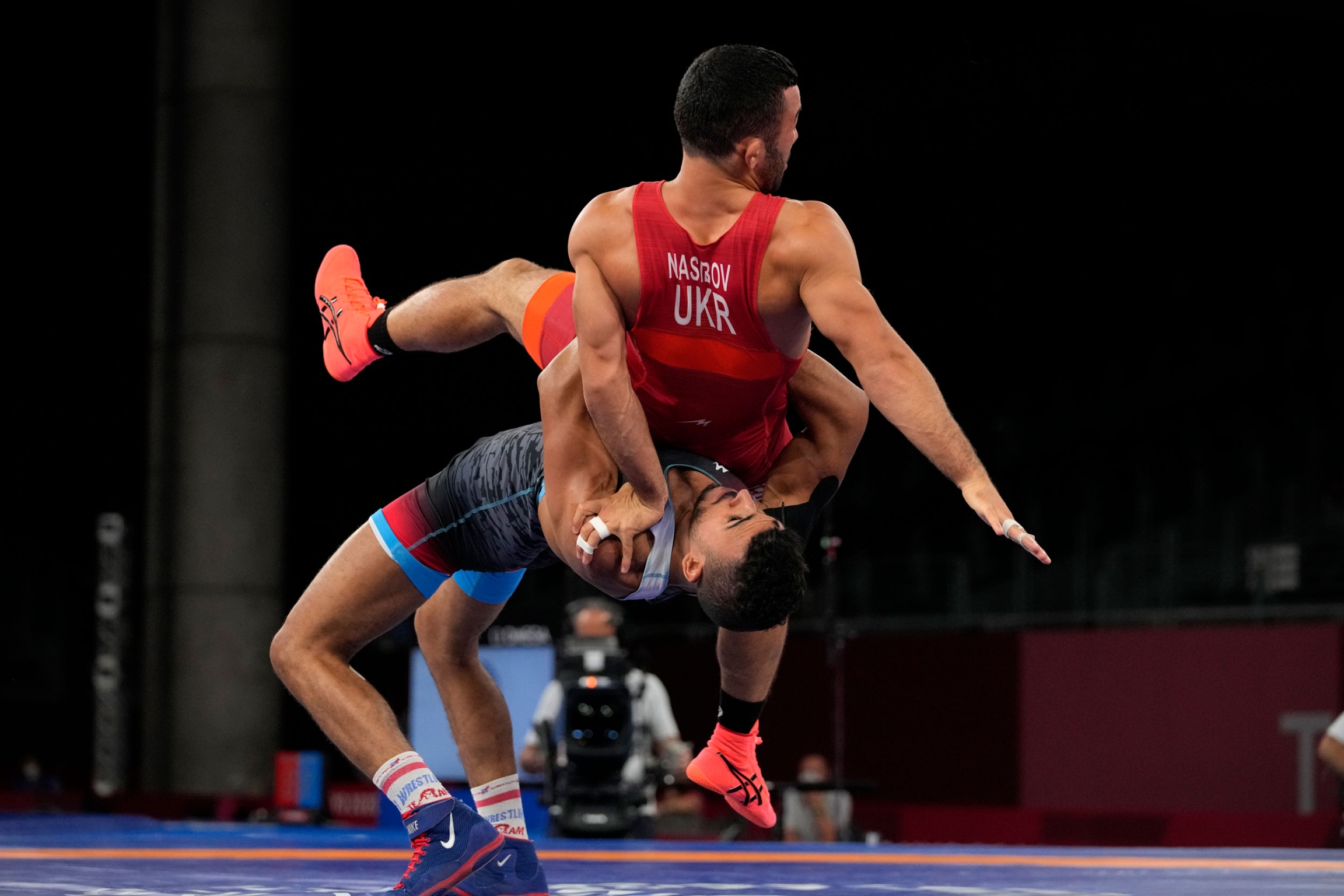Ukraine's Parviz Nasibov, top, and Egypt's Mohamed Ibrahim Elsayed compete during the men's 67kg Greco-Roman wrestling semifinal match at the 2020 Summer Olympics, Tuesday, Aug. 3, 2021, in Chiba, Japan. 
