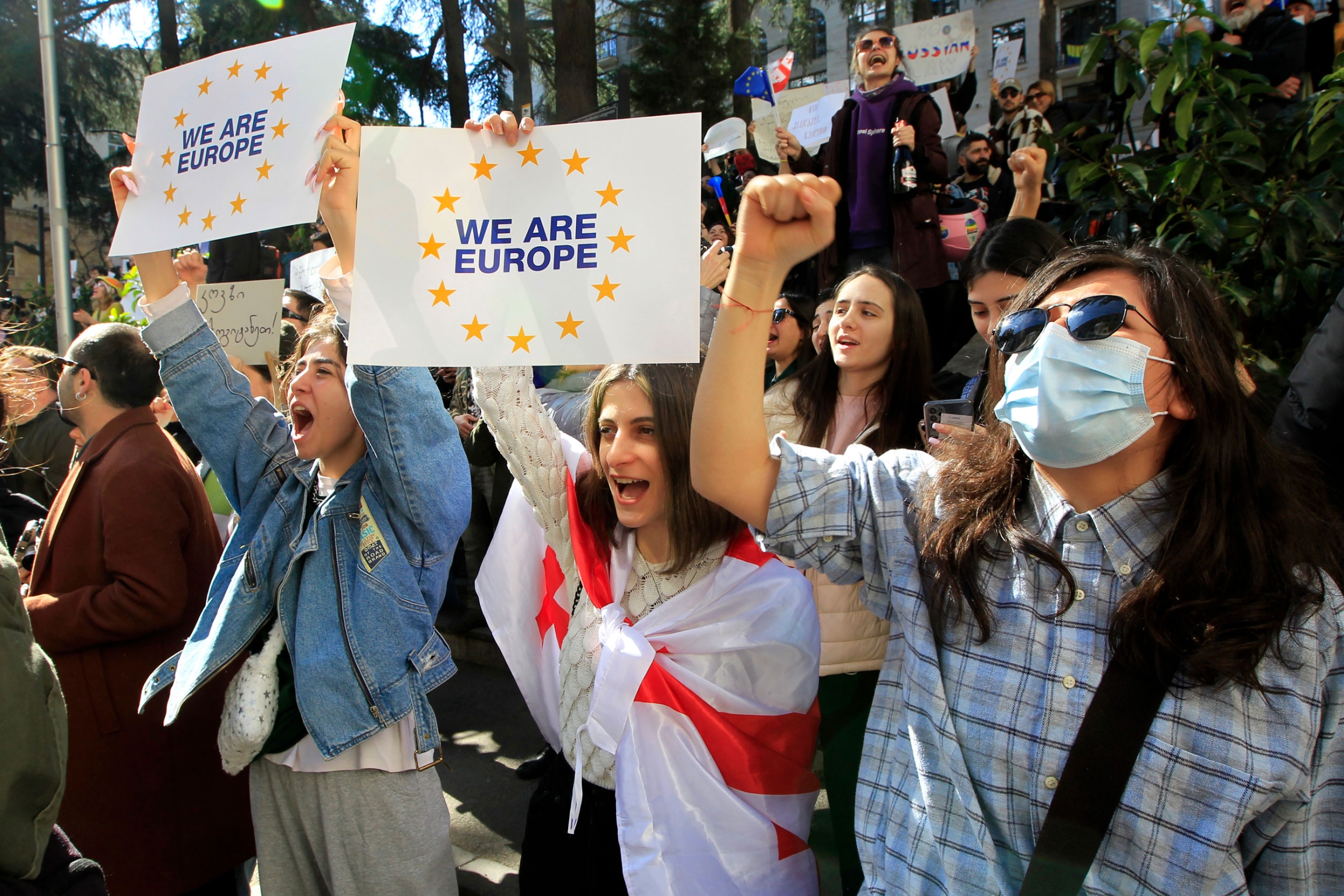 Protesters shout slogans during a rally against a draft law aimed at curbing the influence of 