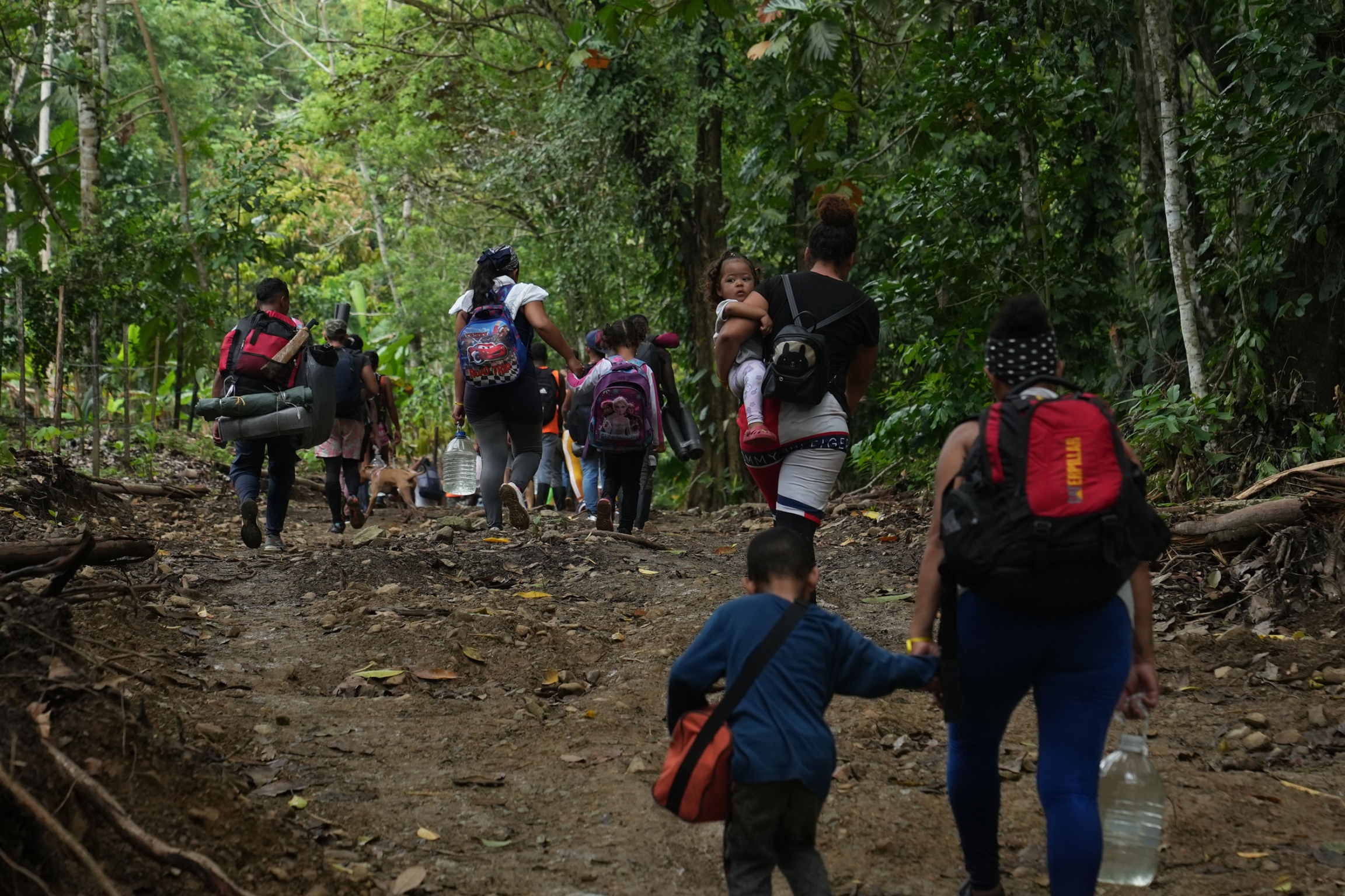 A group of Venezuelan migrants begins the grueling three day trek across the Darien Gap, as they leave the Colombian village of Capurgana. 