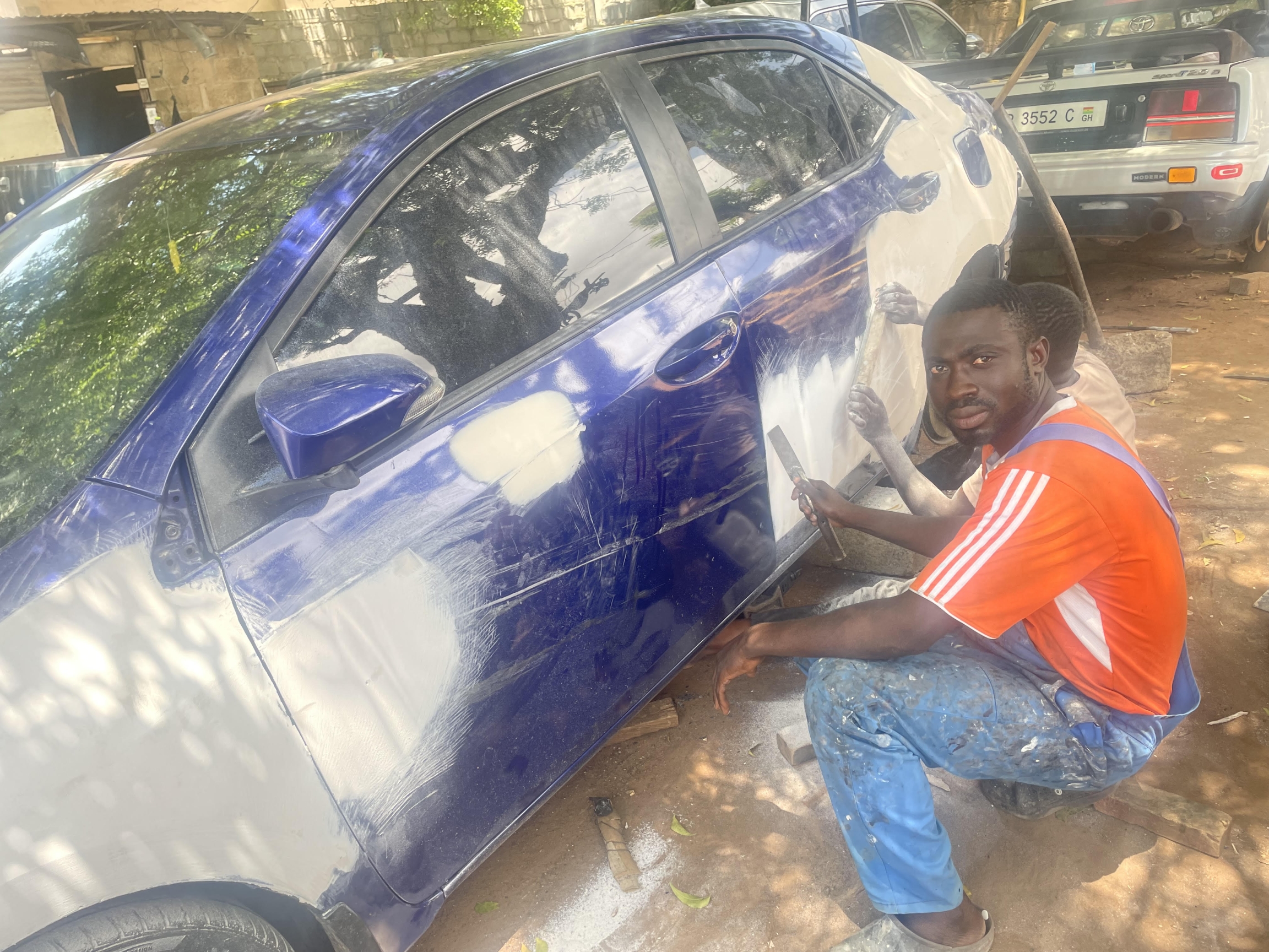 man repairing car