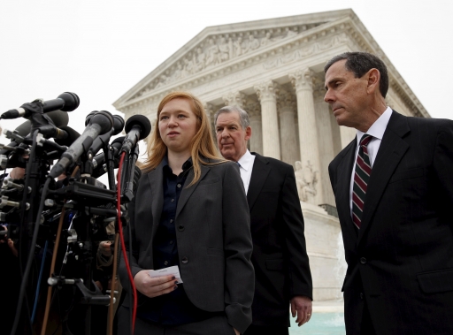 Woman at podium in front of Supreme Court