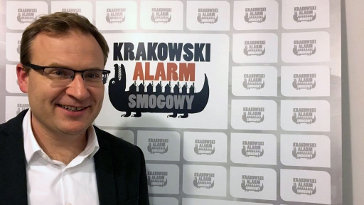 In 2012, Andrzej Guła and several friends founded Krakow Smog Alert to raise awareness of the city's smog problem. A man poses in front a screen for a photo.